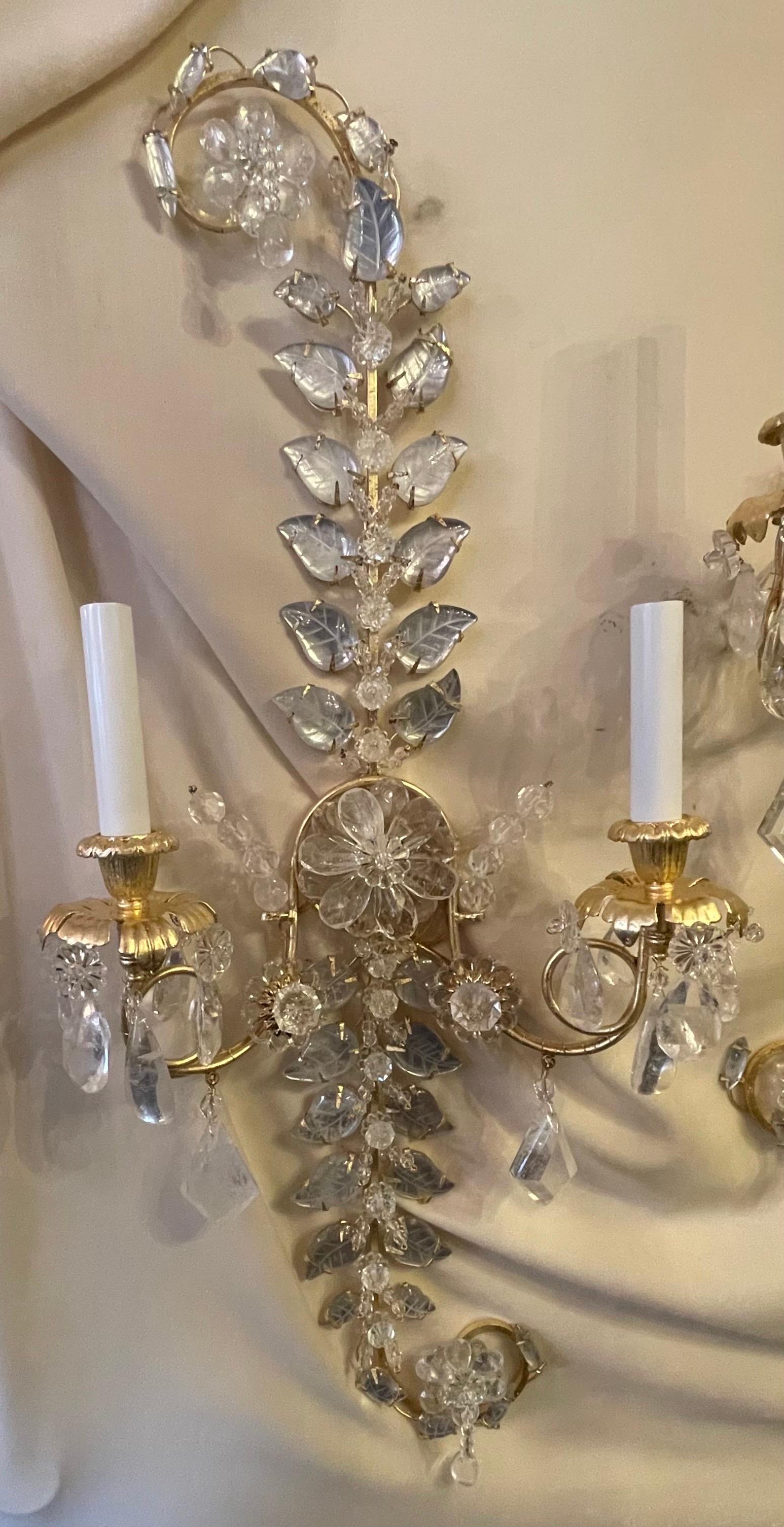A wonderful large pair of French Maison Baguès style gold leaf gilt and rock crystal leaf paisley form two arm sconces each rewired with new candelabra sockets.

