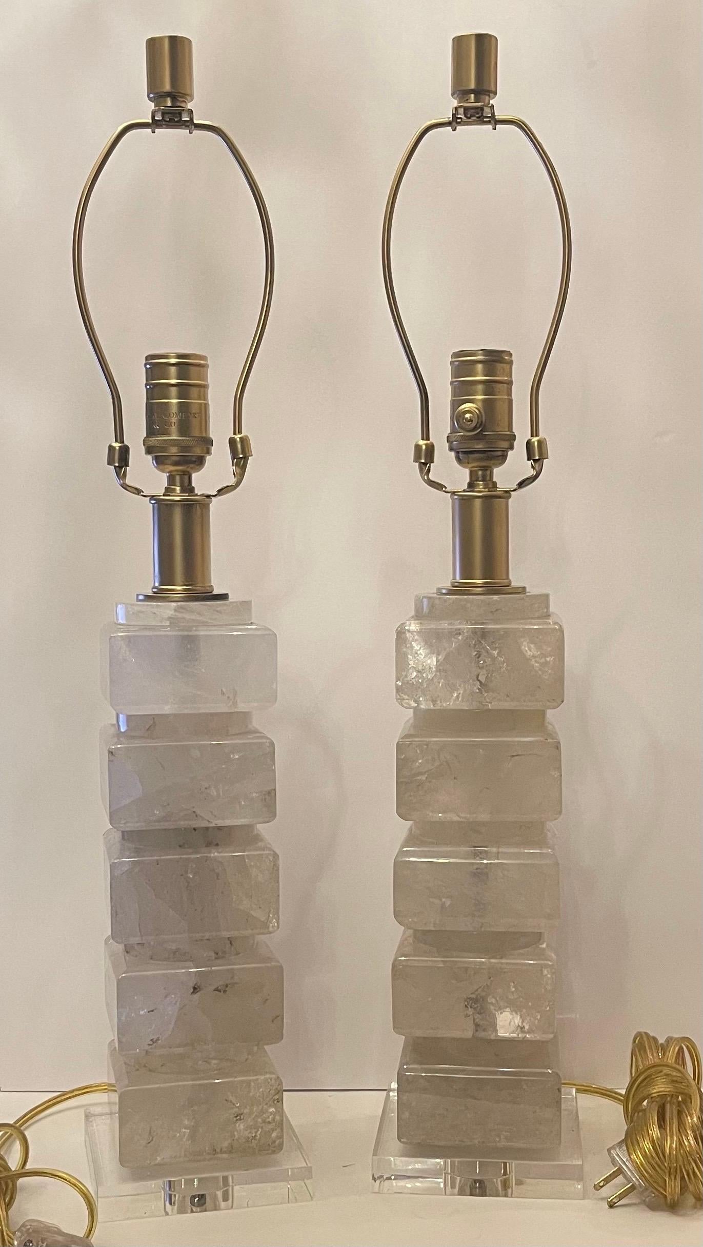 A Beautiful Pair Of Mid Century Modern Transitional Stack Block Rock Crystal Column Form Table Lamps With Gold Gilt Hardware & Sockets Mounted On Lucite Bases.
Newly Wired And Ready To Enjoy