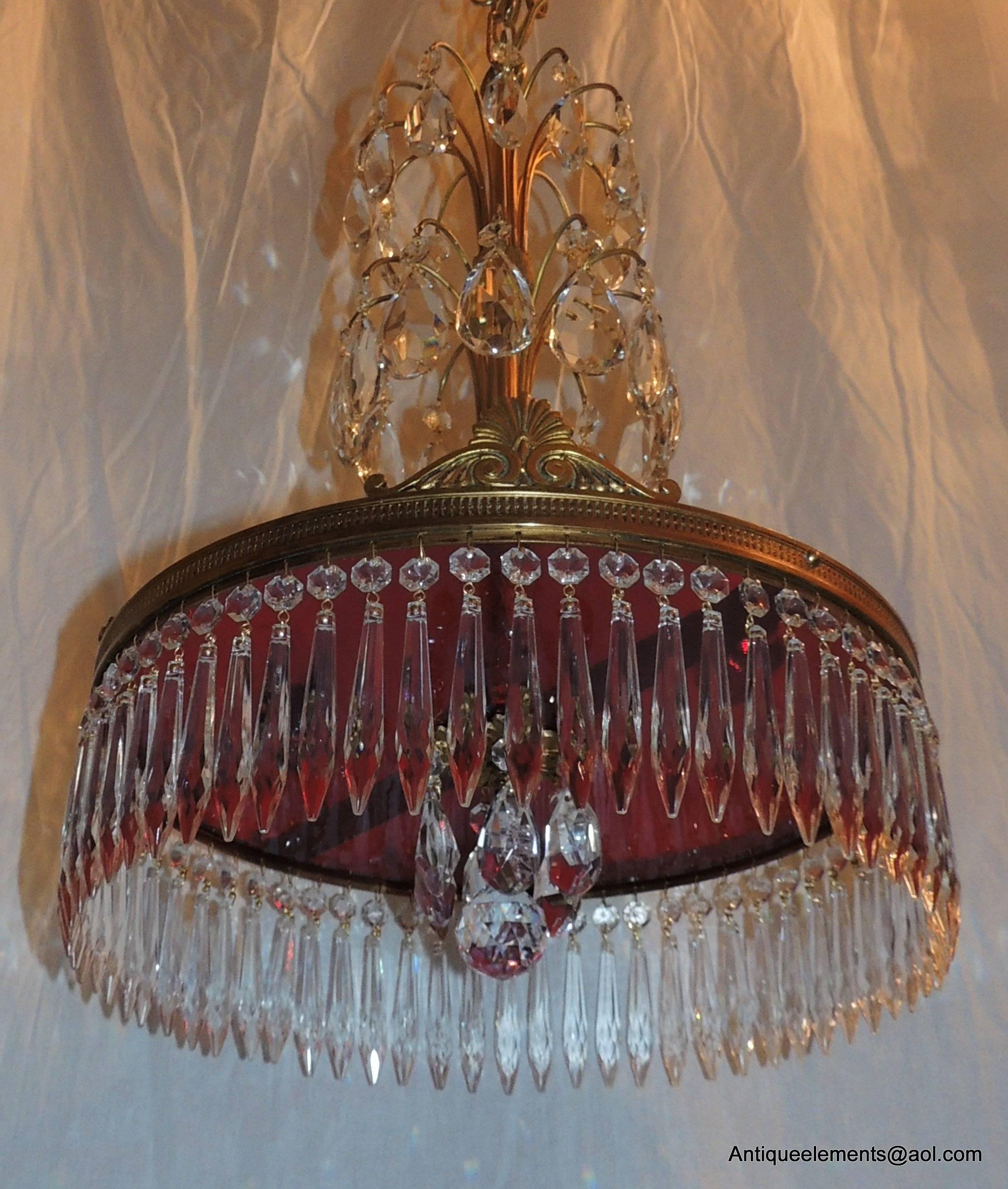 Wonderful French Baltic doré bronze chandelier with two top layers of crystal prism drops and wonderful red crystal under plate surrounded with beautiful crystal spears and drops. Surrounding the bronze trim are beautiful etched details and four fan