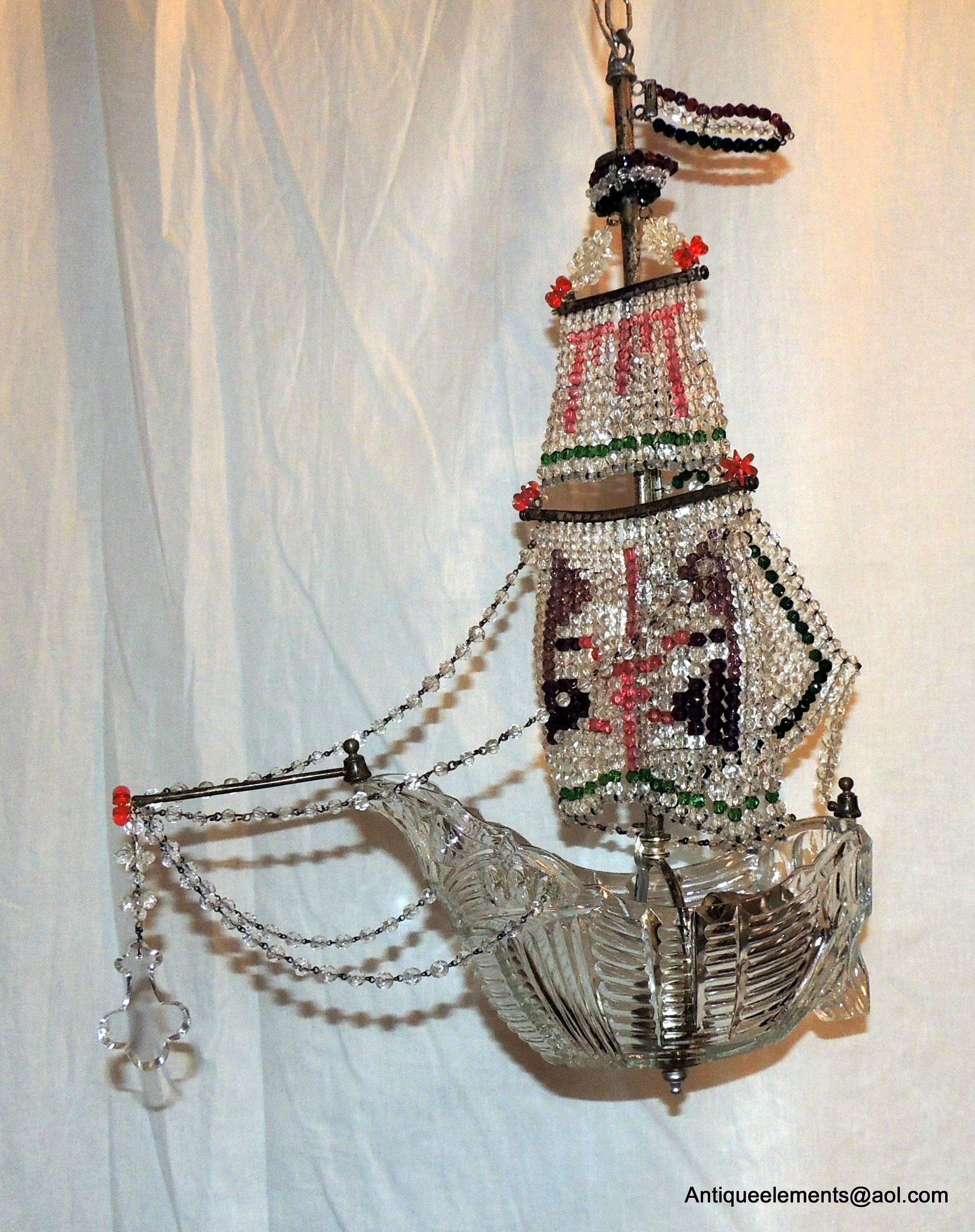 A very unusual  Italian chandelier with beautiful cut crystal boat and delicate colored crystal beads that make a design in the form of sails. With a mainsail in front and the jib in the back and finished with a crystal  