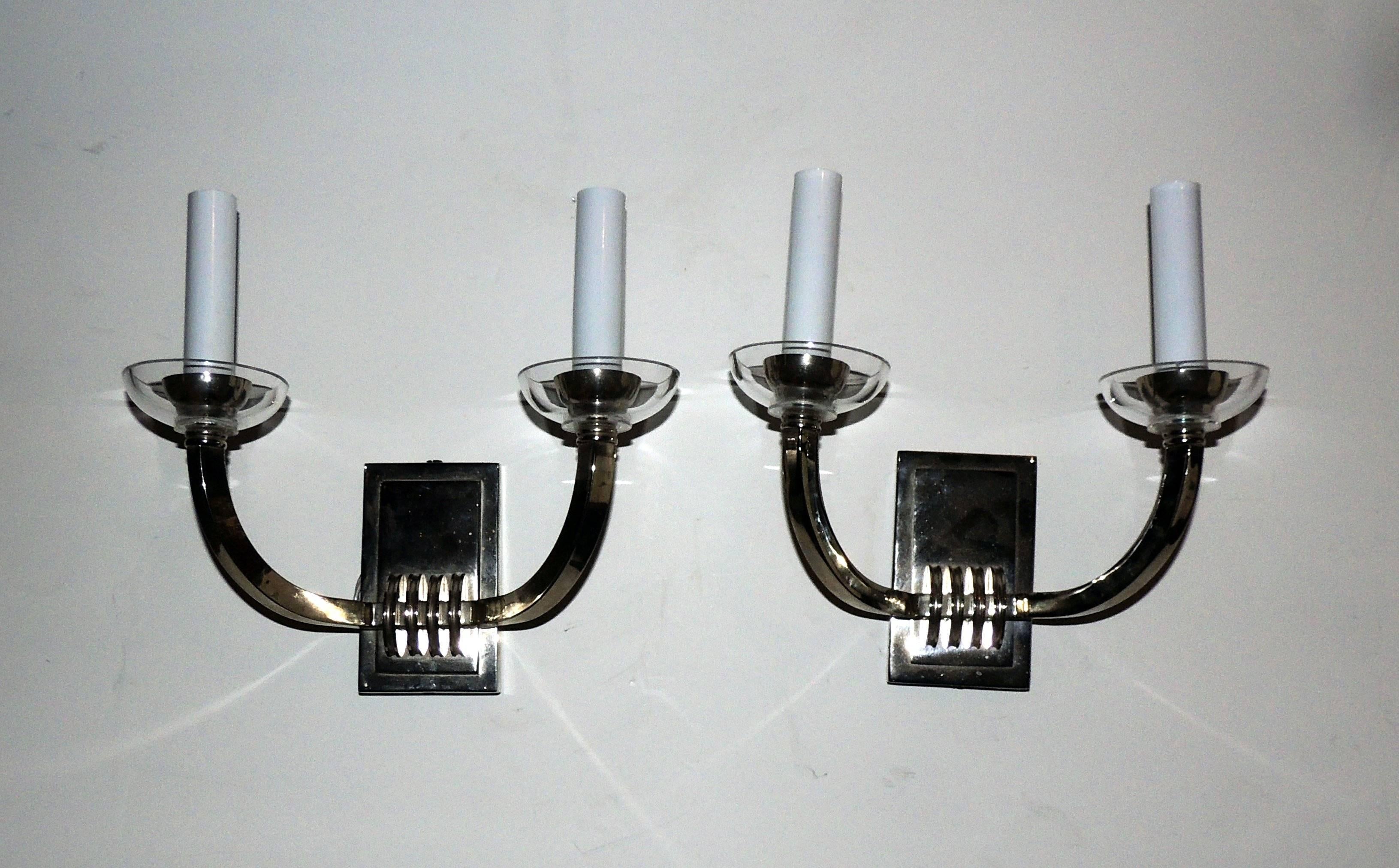 Elegant pair of deco style two-arm chrome sconces with crystal candle cups

 Measures: 9" W x 9" L x 5" D

Newly rewired.