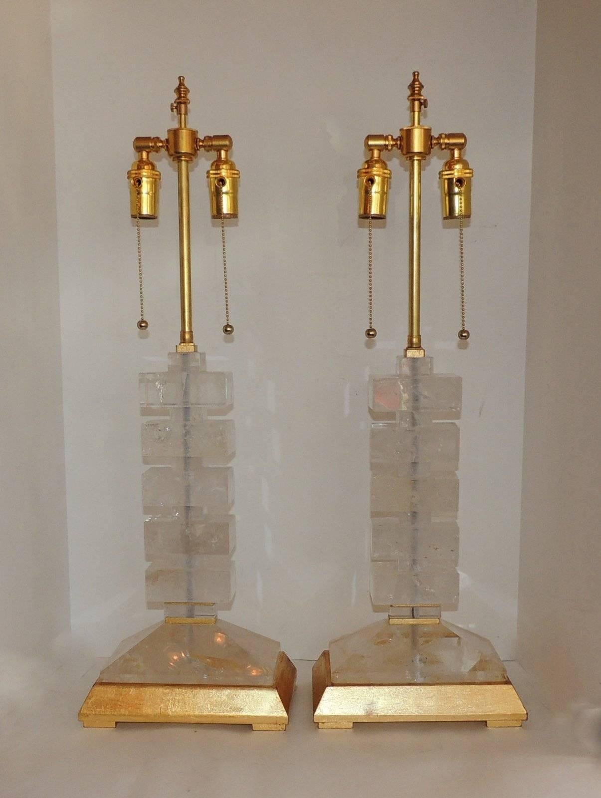 Beautiful pair of modern style stacked rock crystal lamps on gold leaf wood bases.
Measure: 29