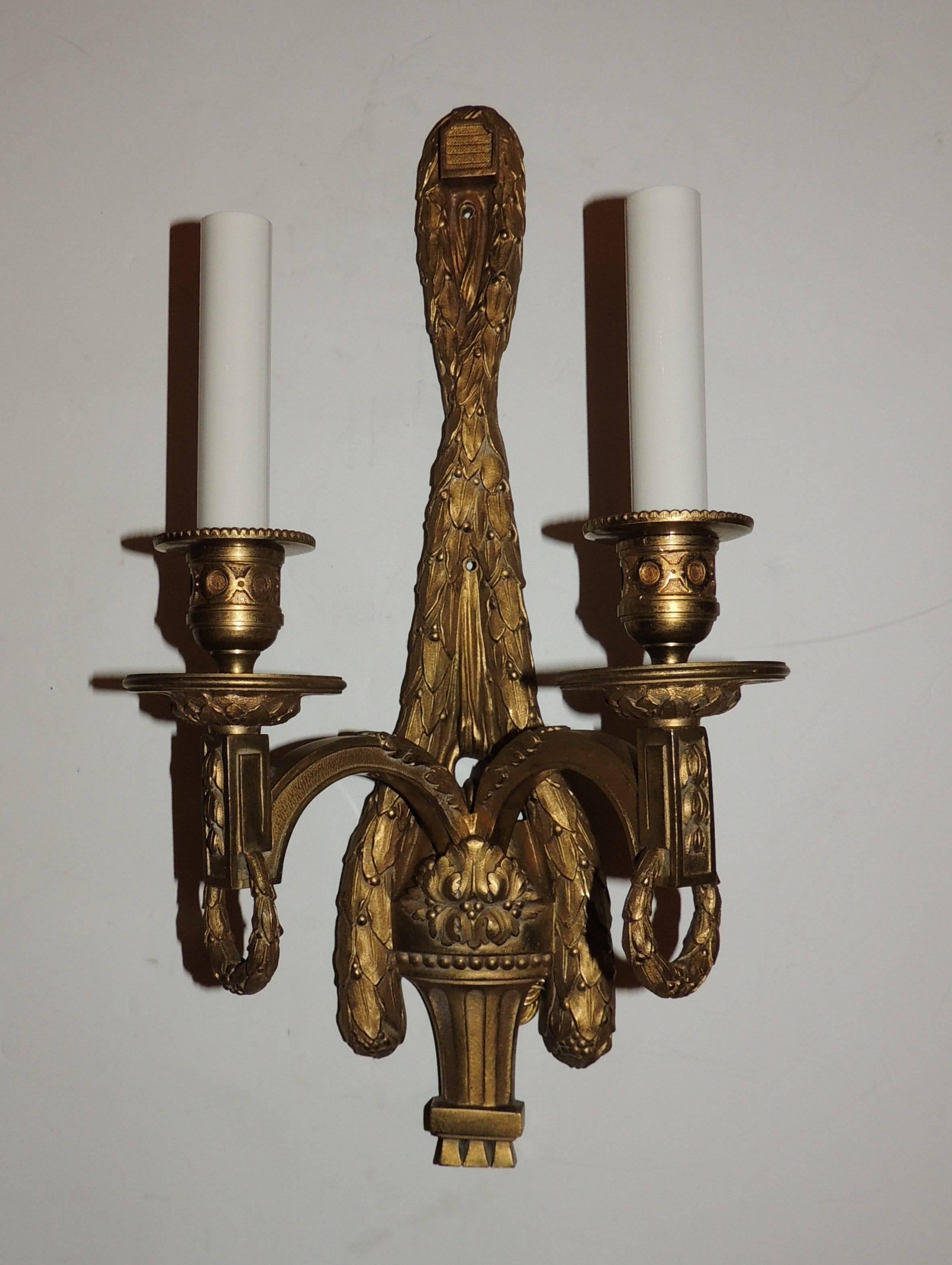 A very fine quality and elegant pair of gilt bronze French style two arm swag draped sconces with wreaths hanging from the arms. The candle cups and bobeches are beautifully decorated.  

15"H X 8"W X 4"D
