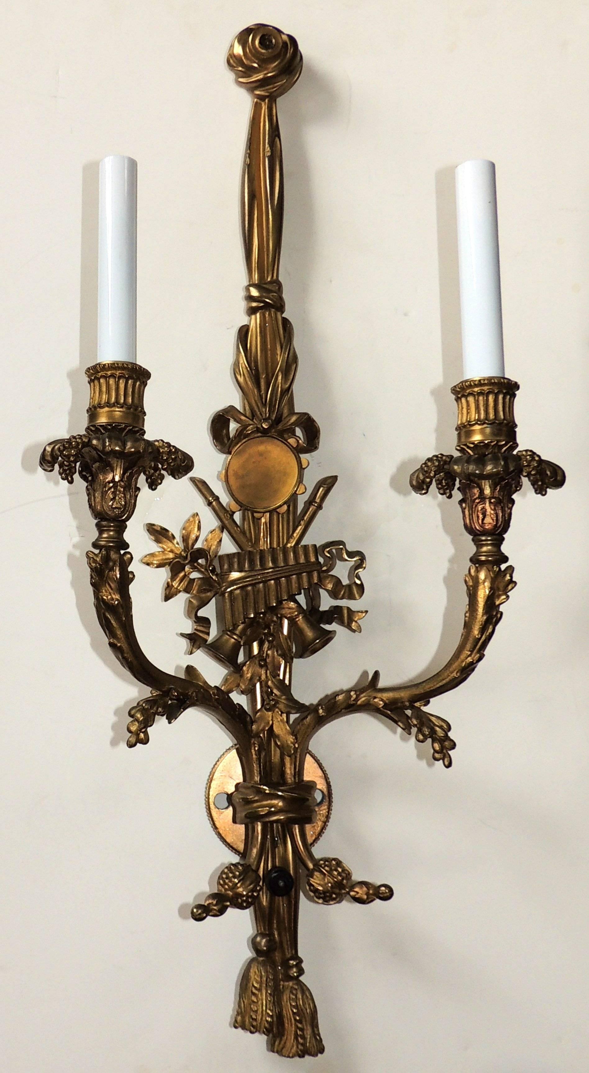 Outstanding Quality Pair Of French Gilt Bronze Musical Instrument & Tassel Floral Sconces.

Measures: 26