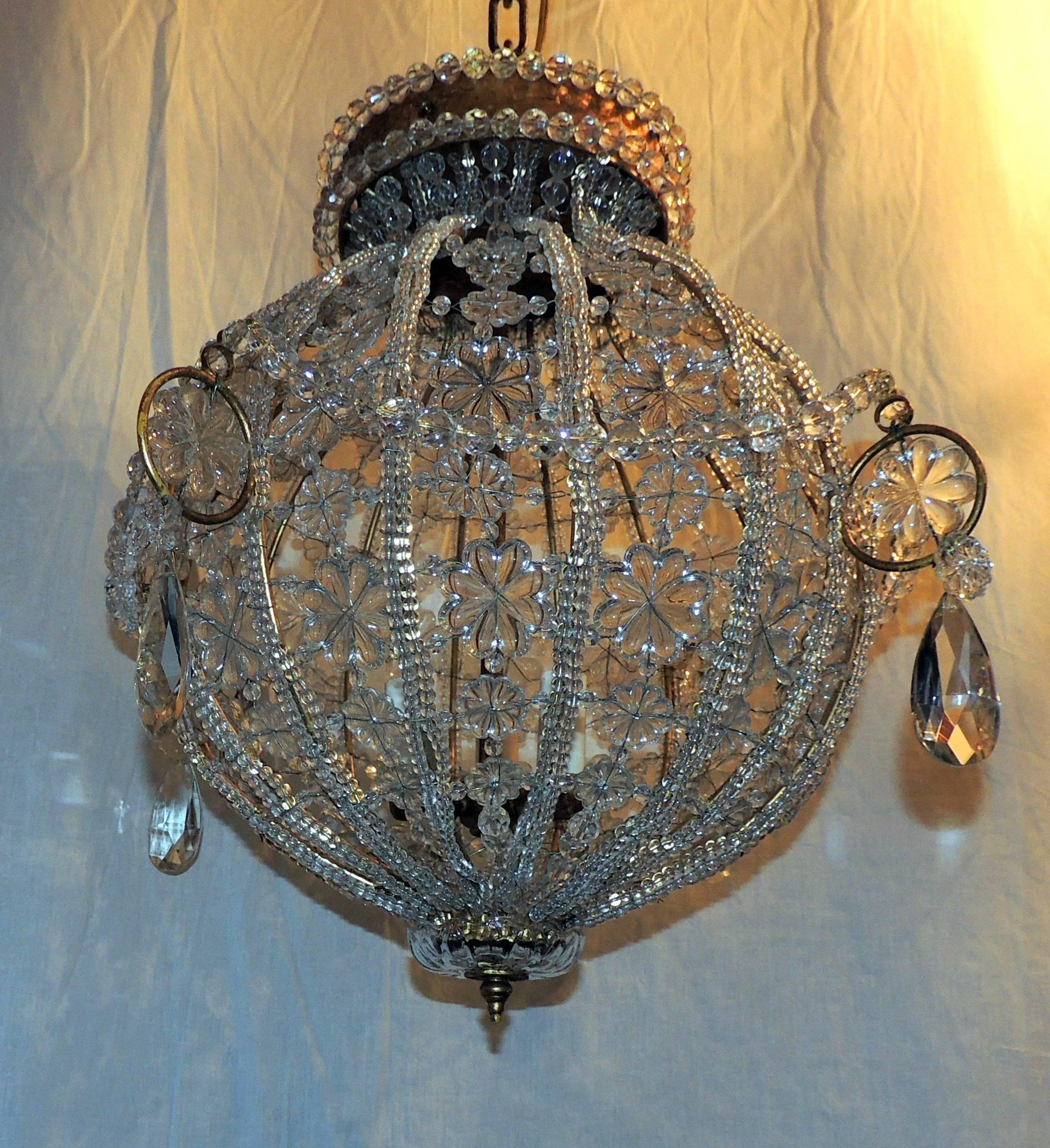 Beautiful crystal flowers and draped crystal beads encircle the doré bronze globe and the three center lights. This crystal will give off a wonderful pattern in any room in your home.

Available either as a flush mount or we can convert to