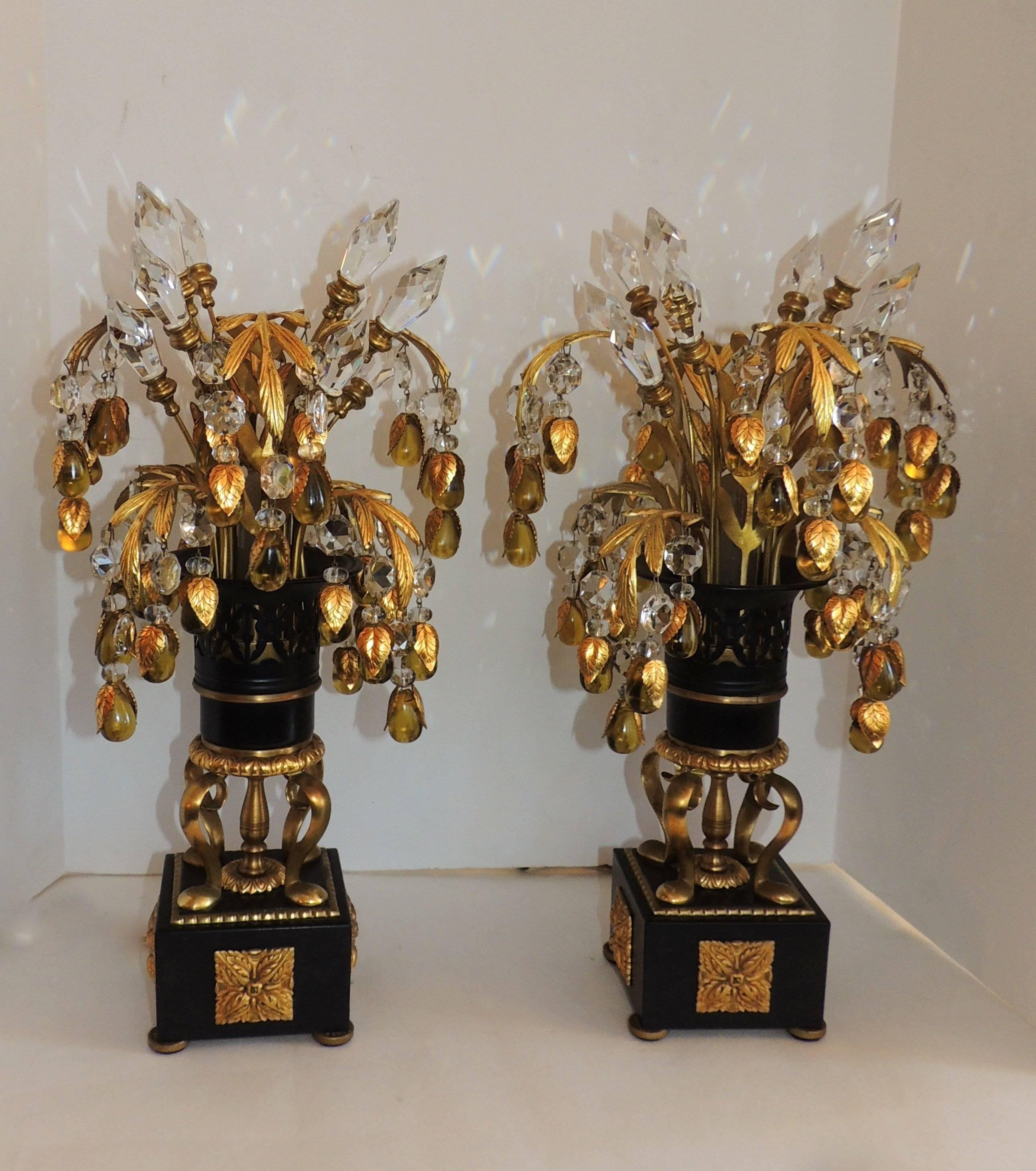 Elegant pair of doré bronze and crystal drop tole lamps
doré bronze leaves and mountings on the tole base are a wonderful backdrop for the flowing leaves that are finished with crystal prisms and amber crystal with bronze leaf overlays. Crystal