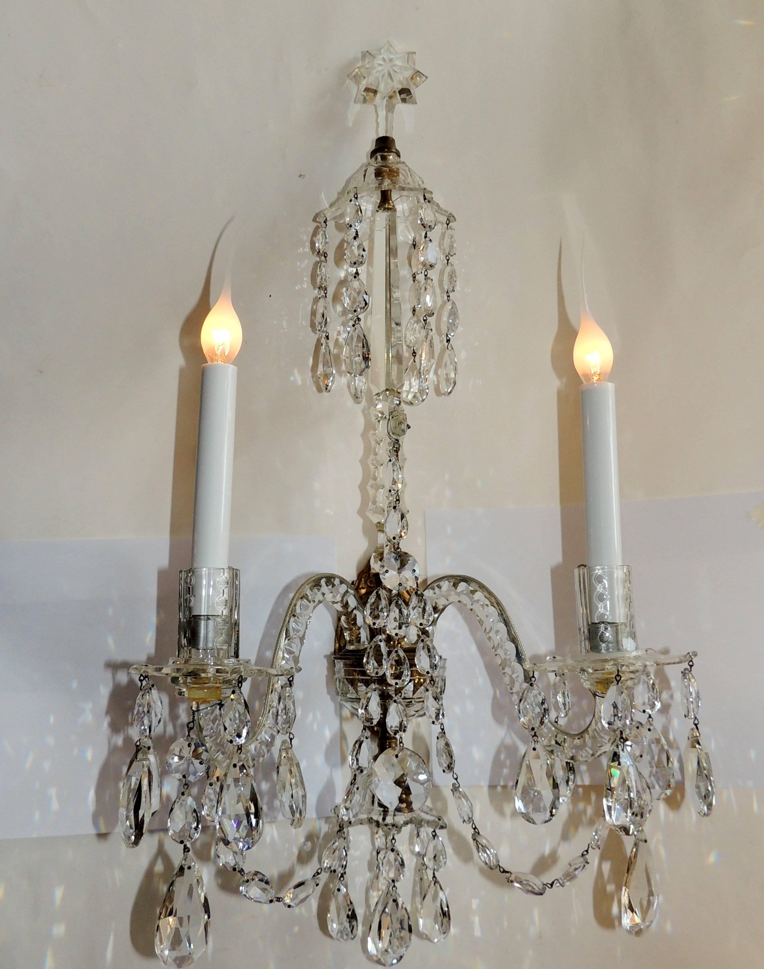 This elegant pair of all crystal sconces have beautiful cut crystal arms and star-shaped candle cups. In the center, a third-arm rises upon which draped crystal beads accent the center bronze support encased in crystal and a star-shaped crystal