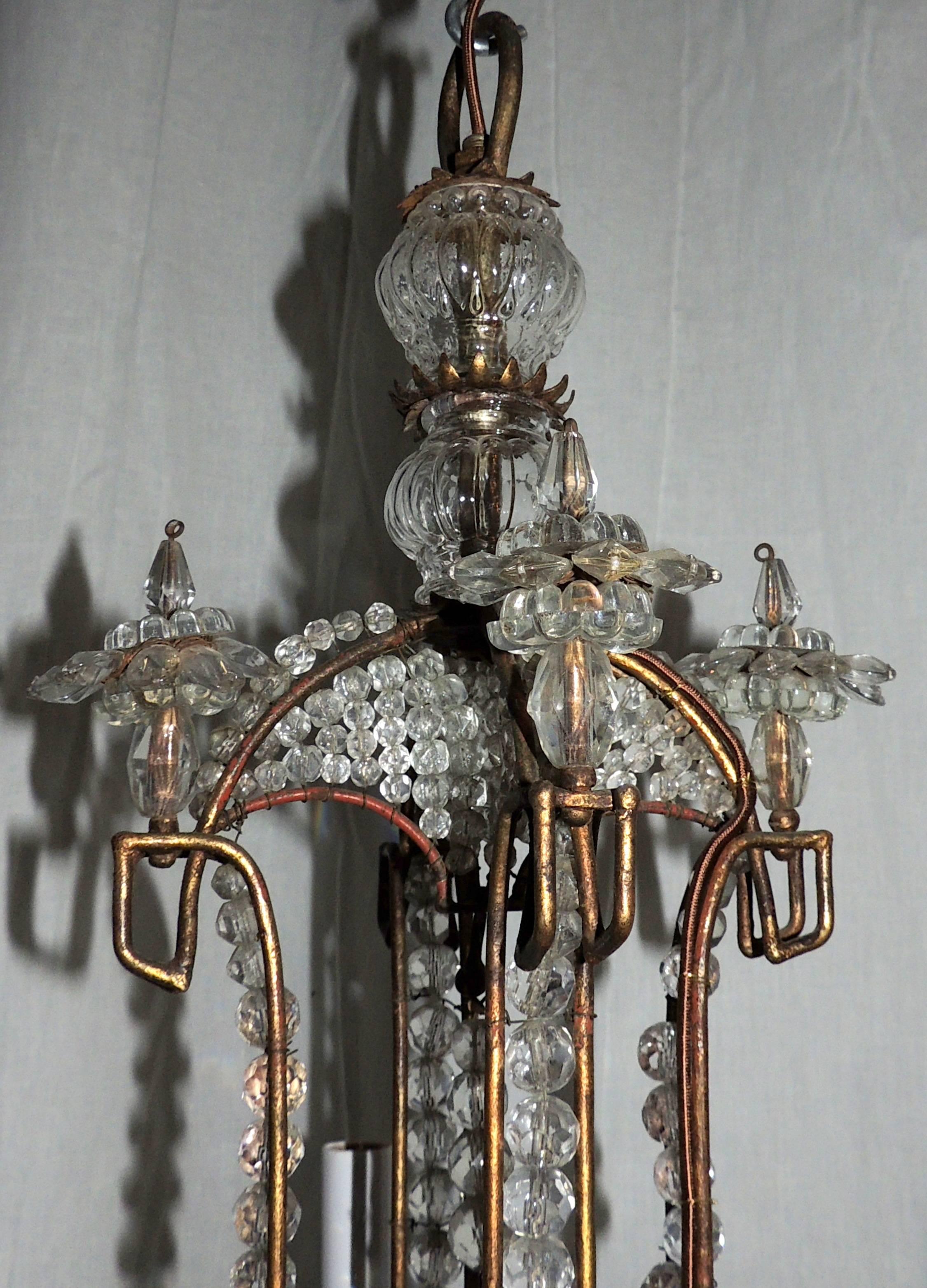 A wonderful beaded Italian baguès style antique gold gilt, vintage tole chandelier in a pagoda form fixture.