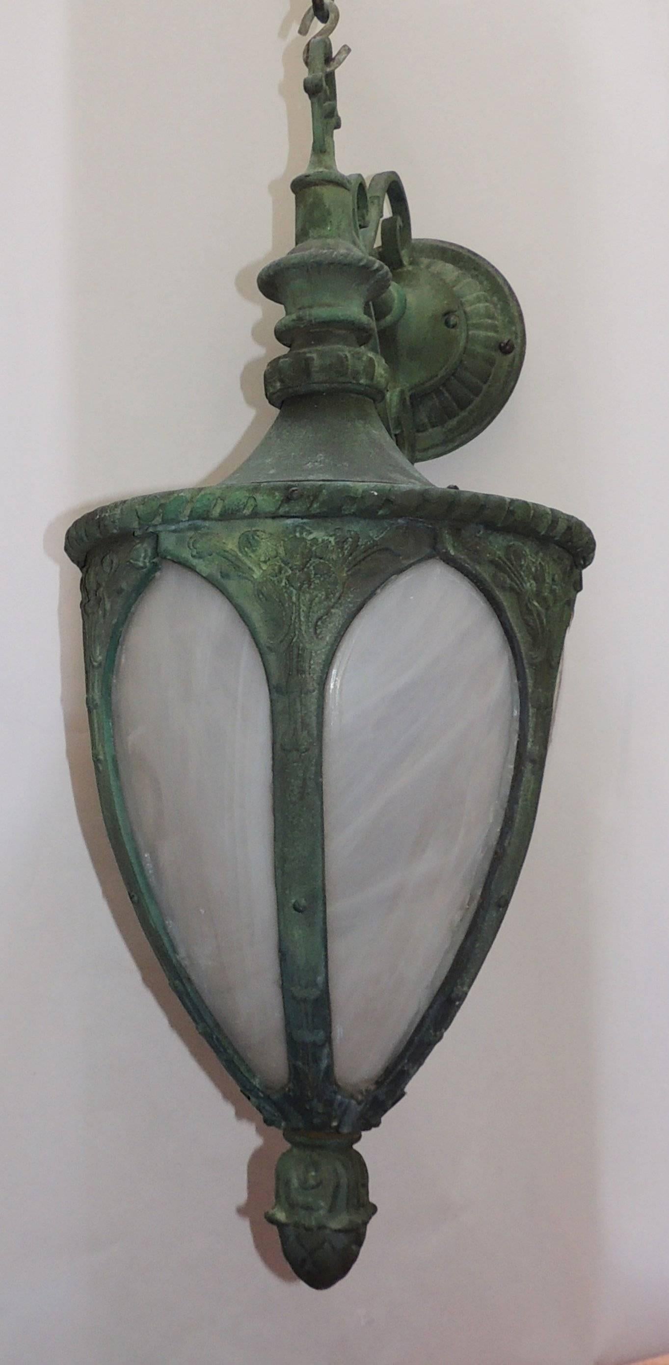 Outstanding set of four 19th century bronze green leaded glass lanterns exterior sconces. We are able to convert these into hanging lantern fixtures if you desire...

Two pairs available. 

Sold by the pair.
 
Measures: 30