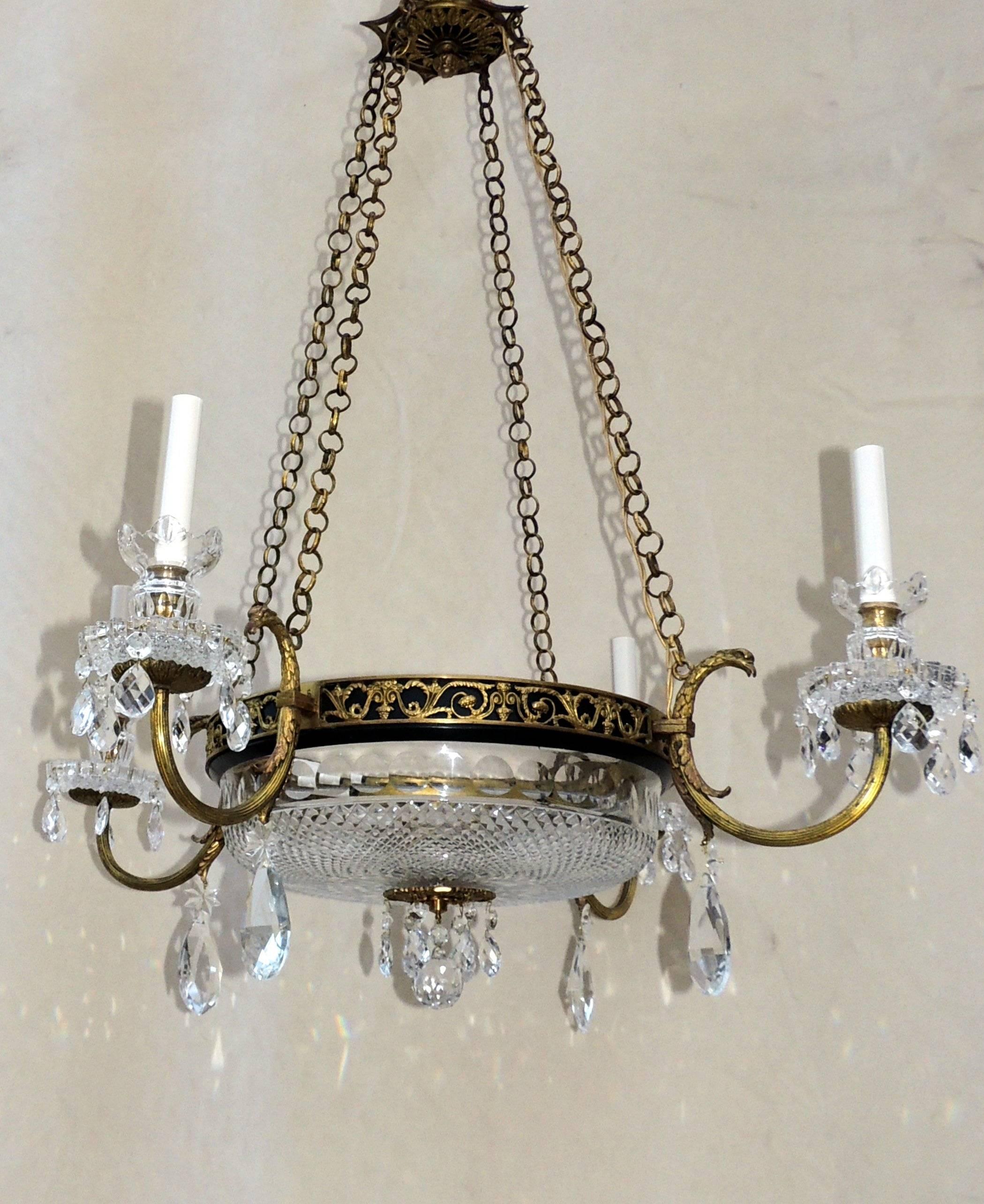 Elegant French Empire doré bronze and patinated crystal neoclassical two-tone fixture with four eagle head arms. This chandelier has a beautiful cut crystal bowl with two interior lights.

Measure:36