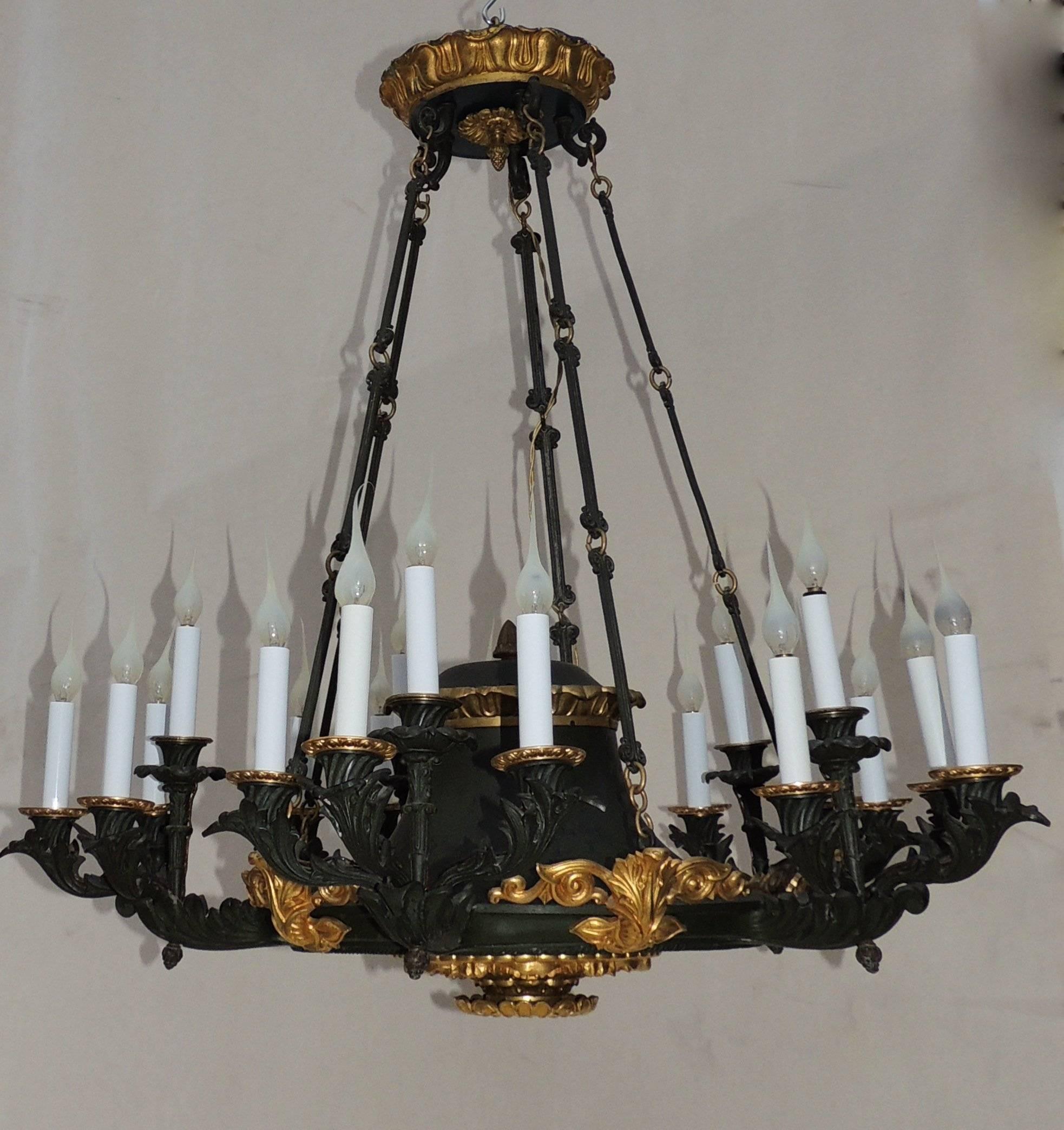 Palatial elegant French empire patinated green tone and doré bronze fifteen-light neoclassical chandelier.

Measures: 32