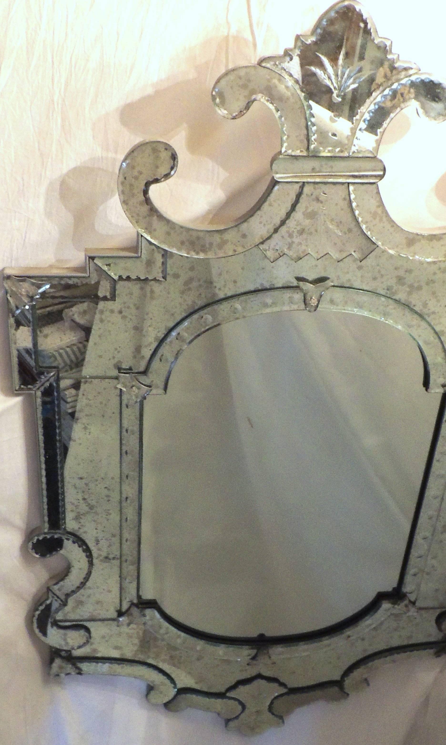 Wonderful large Italian vintage Venetian mirror with scalloped crown etched, appliques and beveled details.

Measures: 37