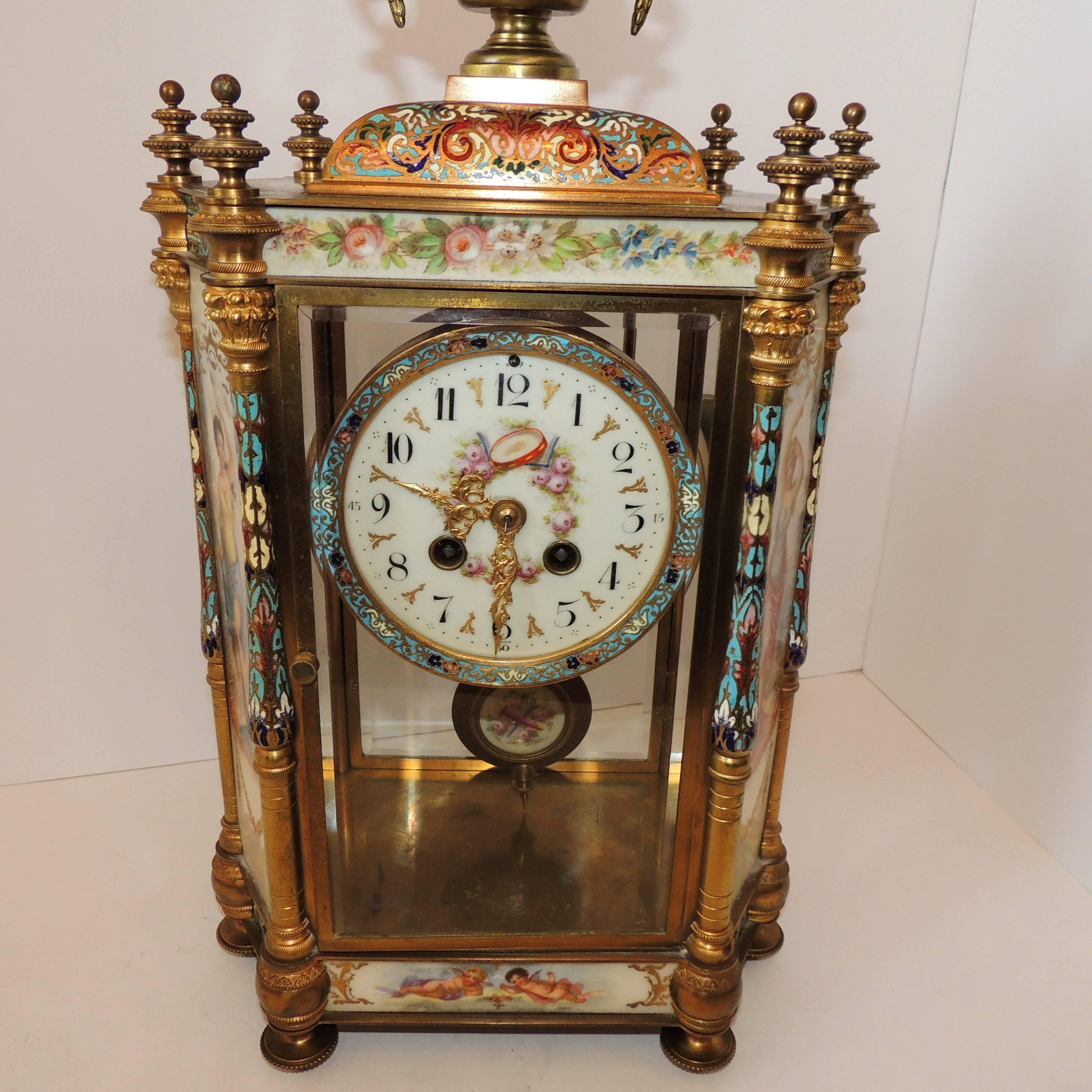 Wonderful sevres mantle clock decorated with sweet maidens and winged cherubs, painted on sevres style porcelain plaques. The enamel accenting and the very fine corners of the doré bronze with wonderful etched filigree detail showing it's quality
