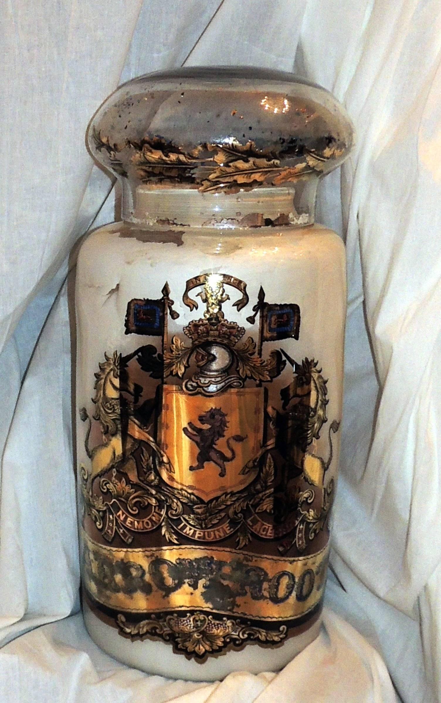 Vintage white pharmacy blown glass apothecary jar with reverse hand-painting.

Gilt leaves surround the cover of this vintage white jar with gilt déCOR.

Measures: 12