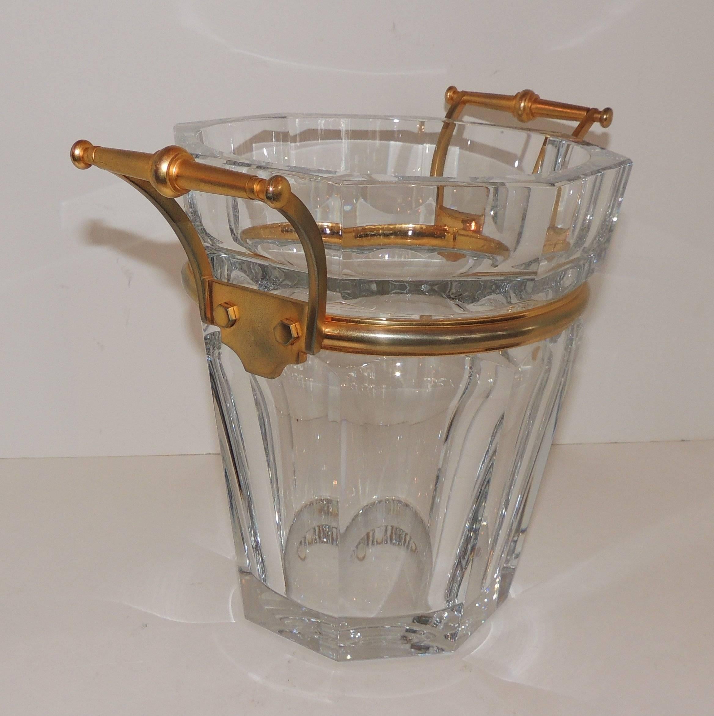Wonderful crystal champagne or ice bucket signed Baccarat and marked with etch on bottom. Gilt bronze band and two handles surround the top have wear.
Minor flee bite to rim from use

Measures: 9
