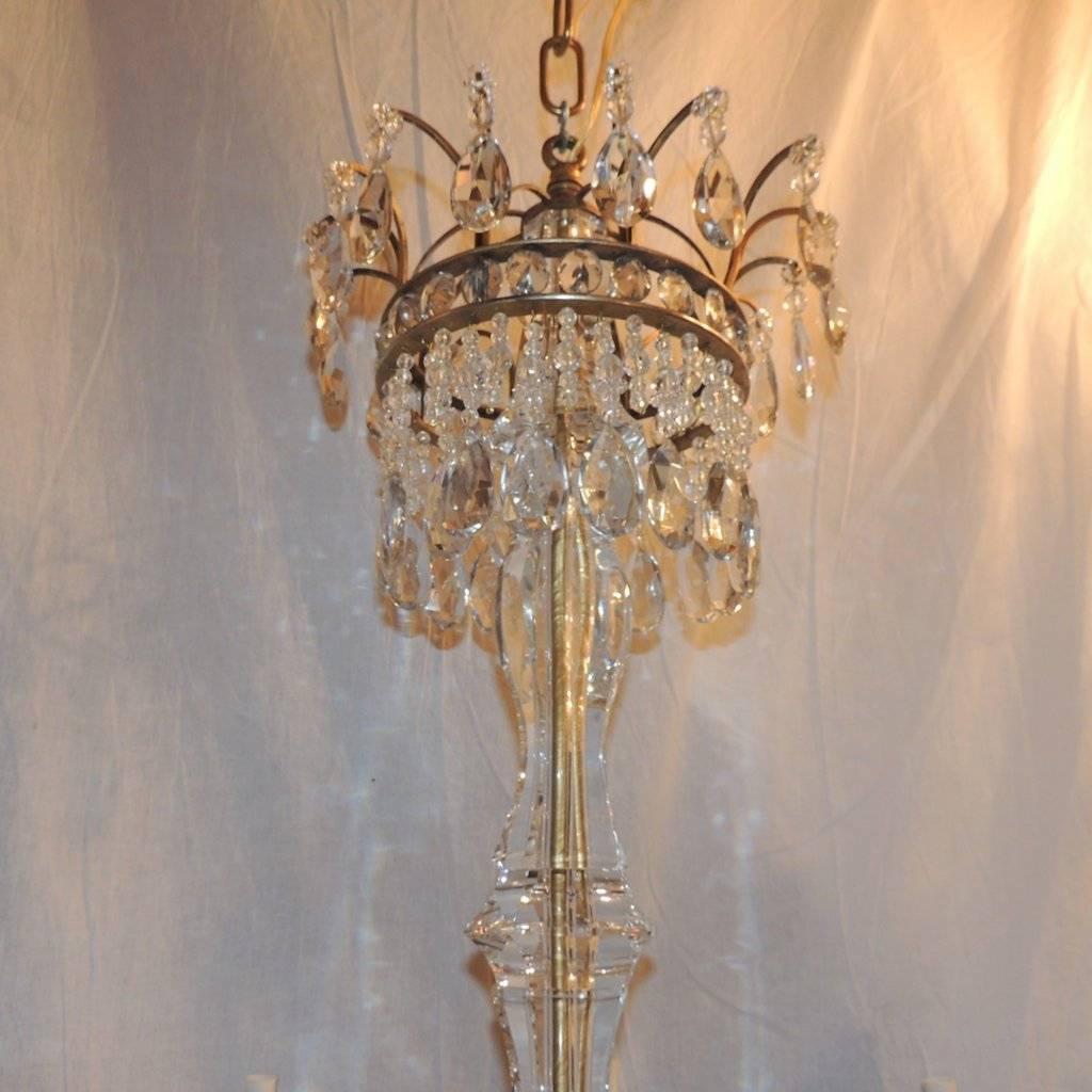 Neoclassical eight light chandelier with crown of prism drops, beautiful crystal center and multi prism border surrounding the red glass plate which is accented with crystal beads and prisms.

Measures: 44