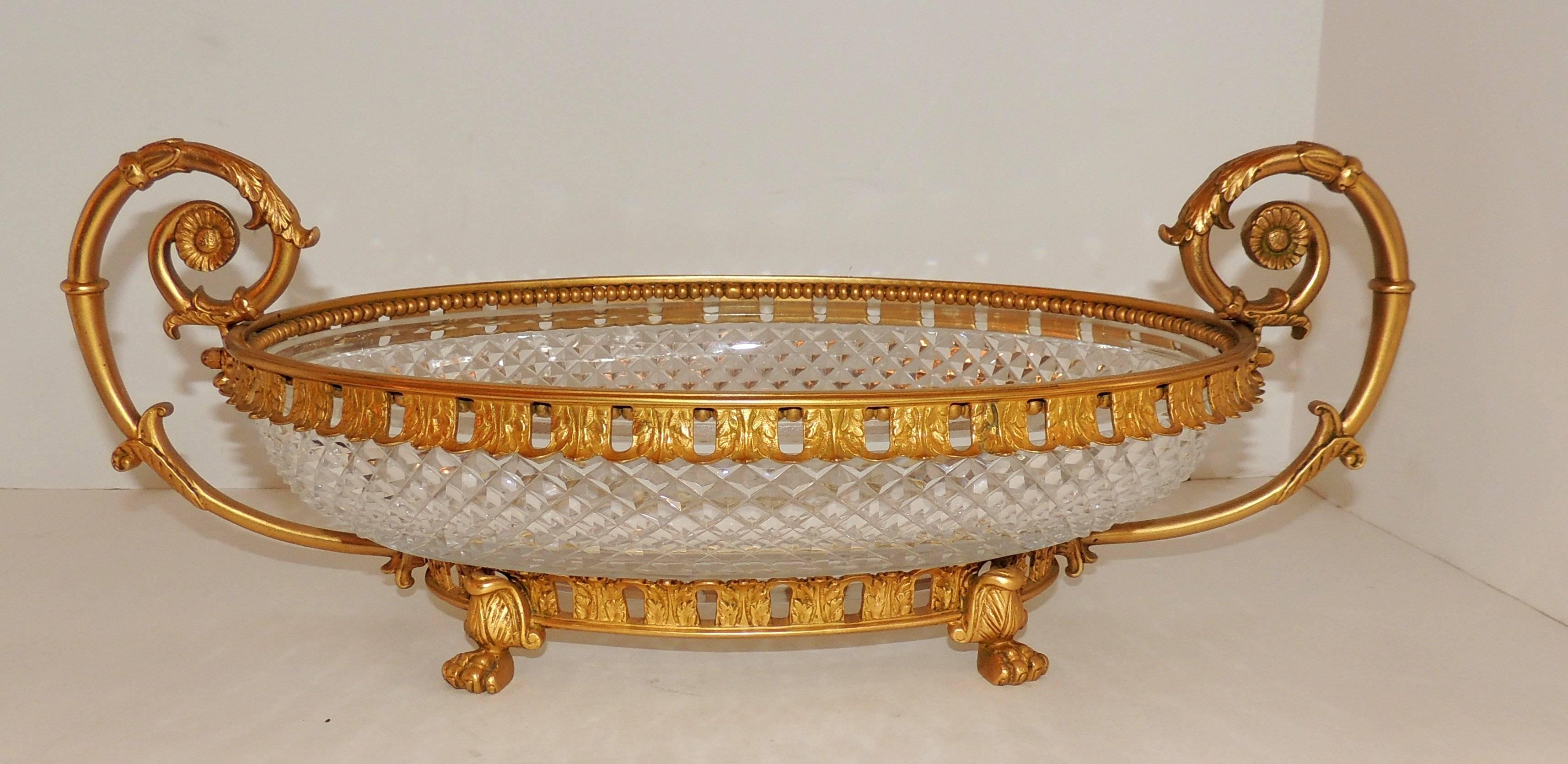 Wonderful 19th century French dore bronze and cut crystal oval centerpiece with lions feet and double handles.

Measures: 17.5" W x 4" H x 9" D.