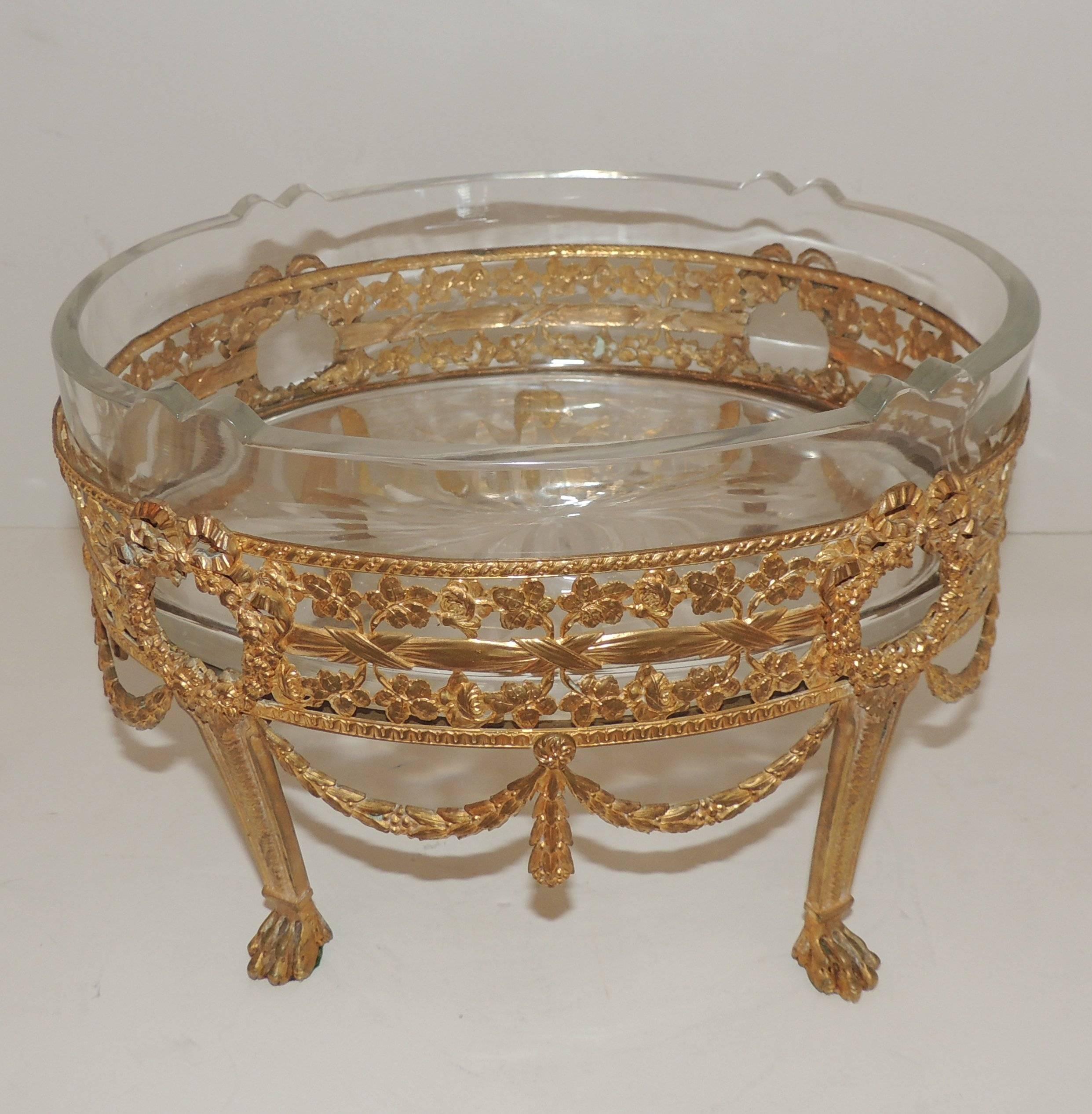 Wonderful French doré bronze bow and swag footed centerpiece with crystal insert with scalloped accents on four corners.

Measures: 10" W x 7" H x 7" D.

 