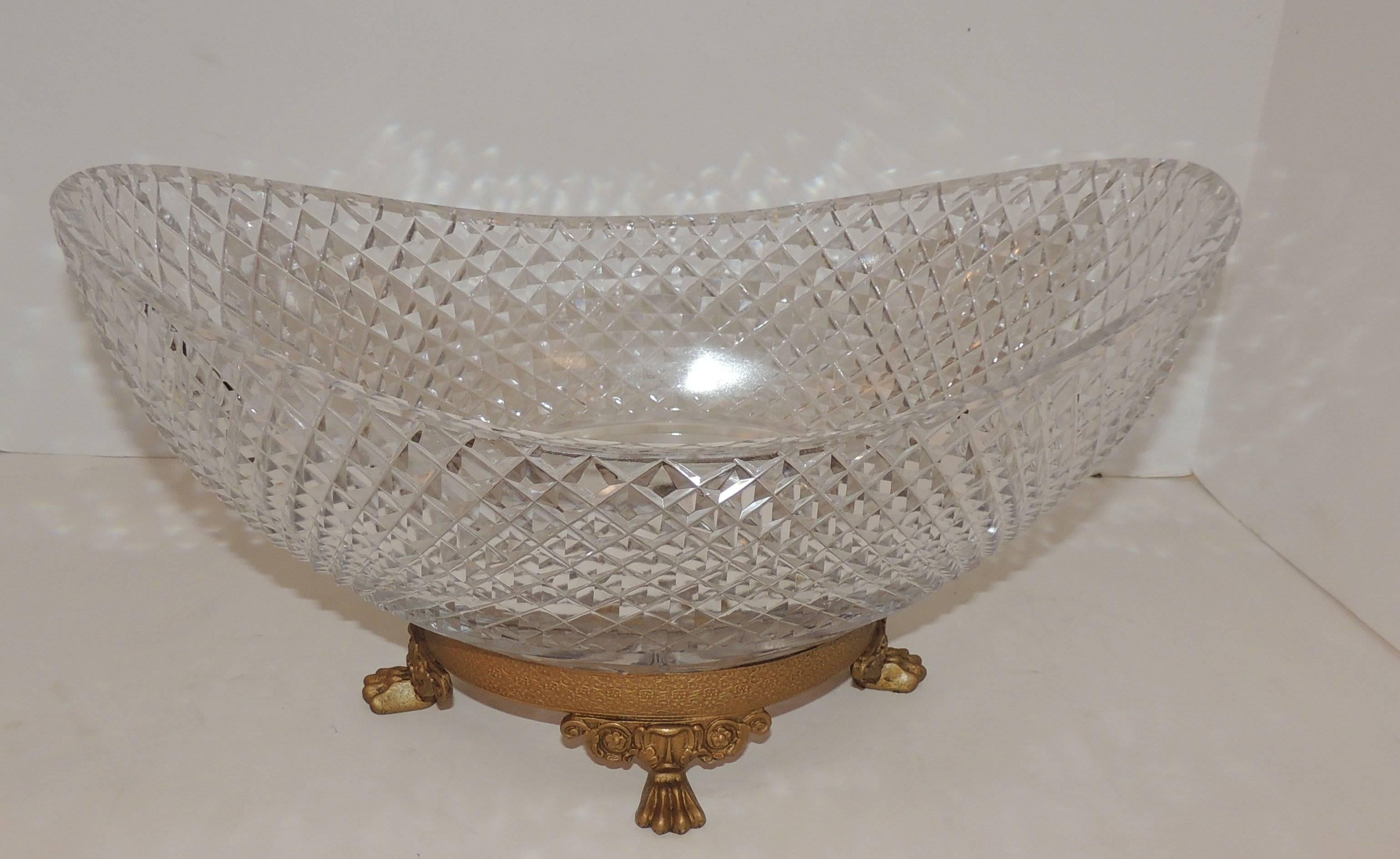 Dore bronze footed centerpiece with oval cut crystal bowl. The bowl is
6" high in center goes up to 8" high on each side.

Measures: 15.5" L x 9" W x 8" D.