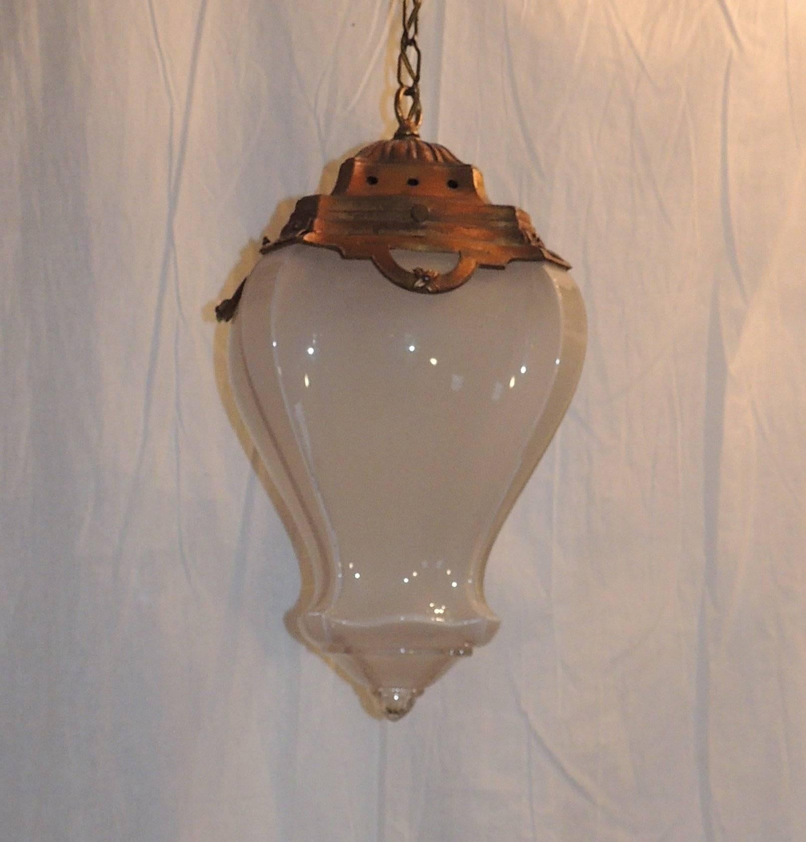 A wonderful gilt bronze crown highlights the beautiful curves of the original milk glass lantern.

Measures: 18