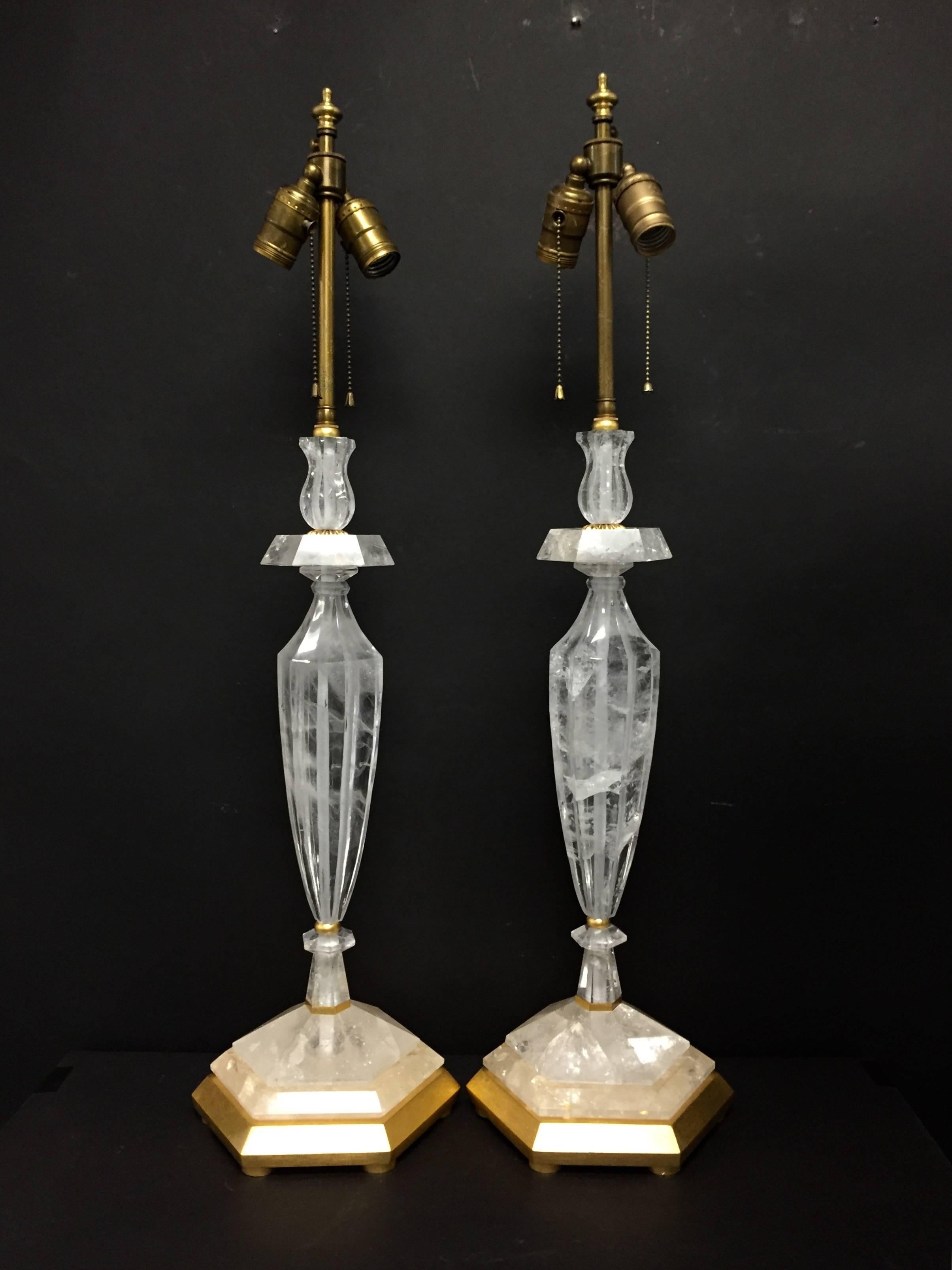 This pair of giltwood and rock crystal lamps are beautifully fluted in an elongated urn shape. Each piece of rock crystal is highlighted with gilt accents.
The lamps are topped with double lights and measure a tall 32" in height.

Measures: