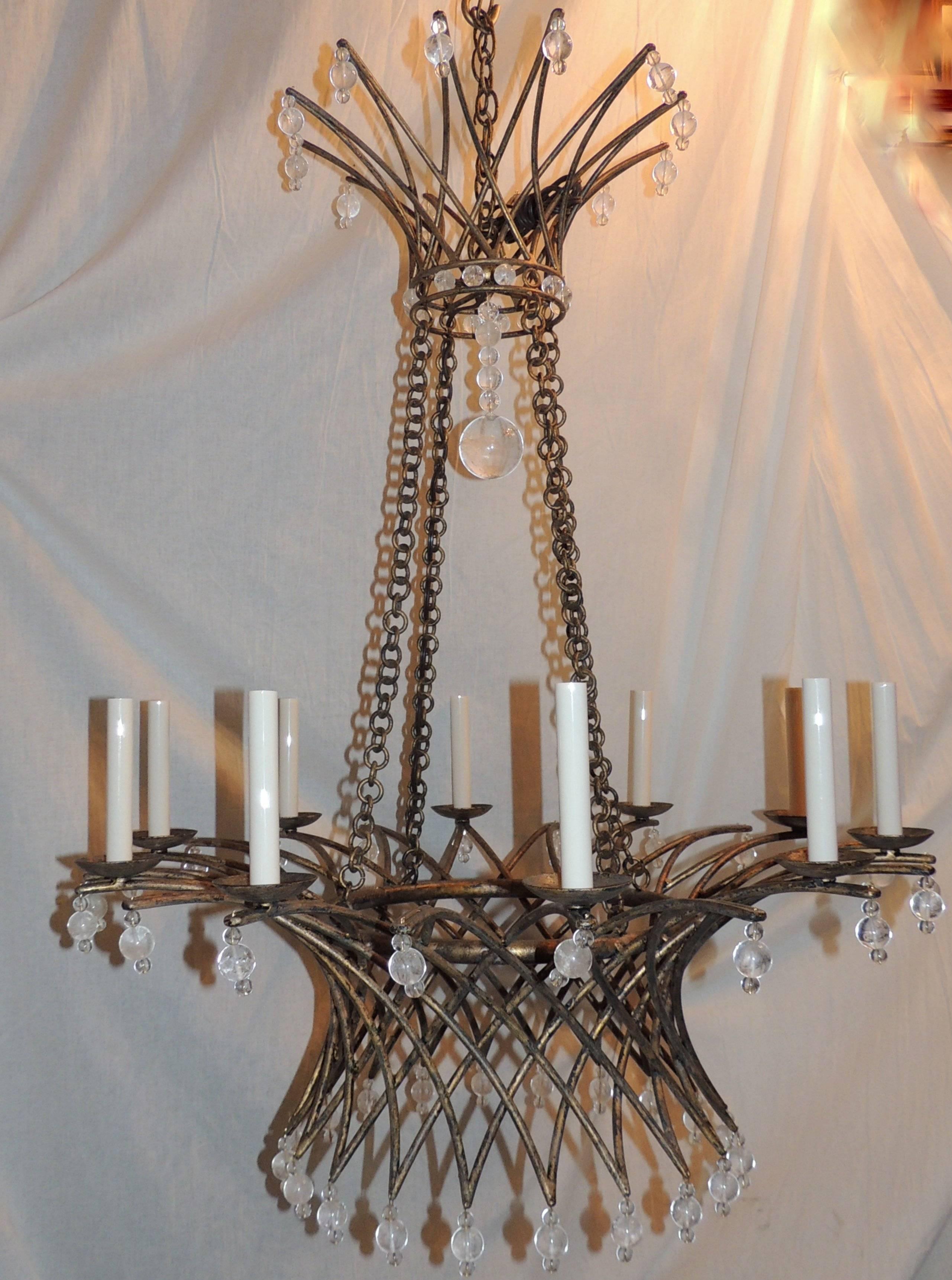 A large ten-light chandelier in a basket form, accented with crystal beads and rock crystal. The crown has crystal beads and a center rock crystal ball highlighting the center.

Measures: 42