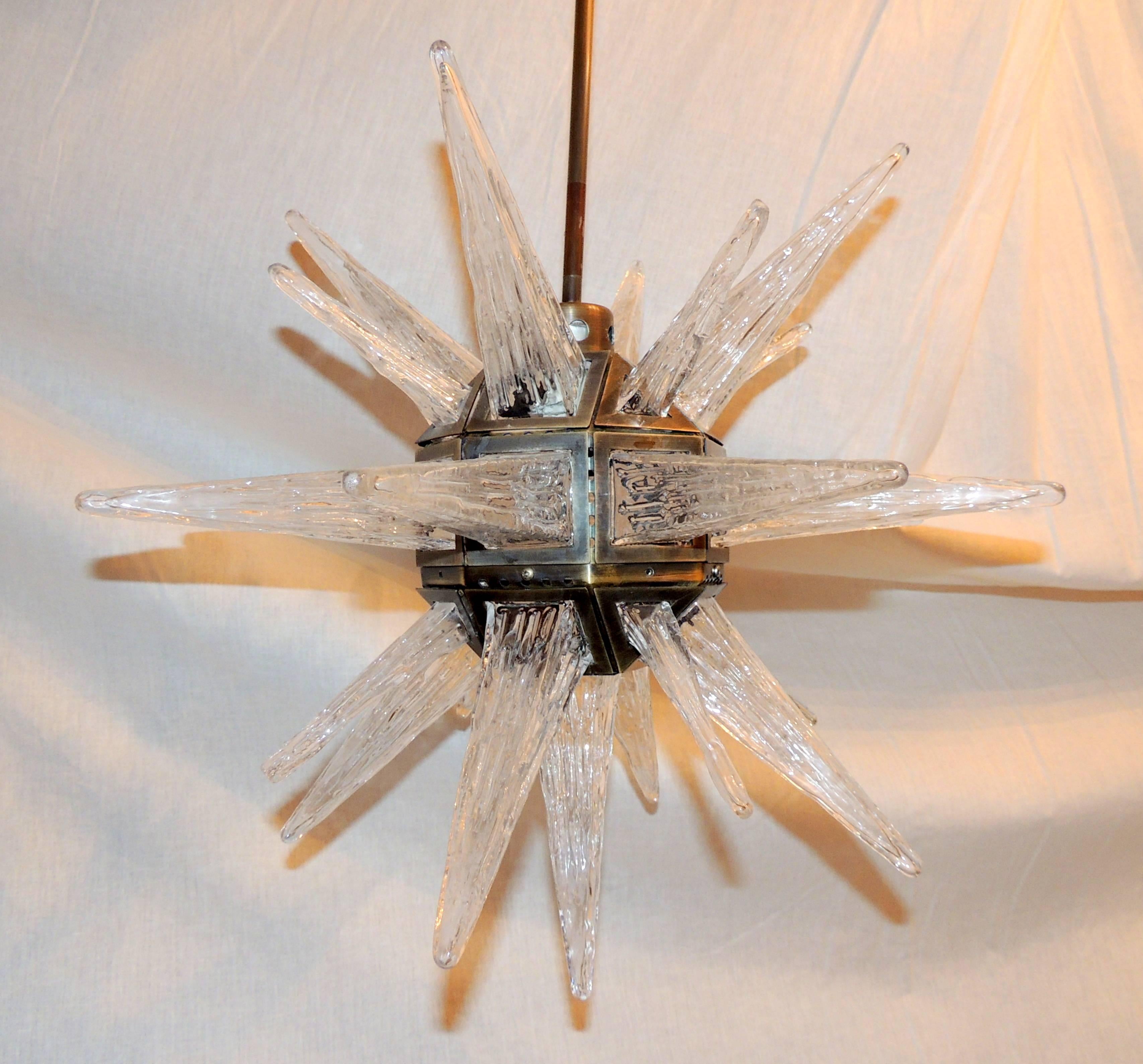 A wonderful vintage star form art glass chandelier fixture with antique bronze brass finished frame. The glass panels are in the form of shaped icicles. They had been removed out of a prominent Florida hotel, undergoing renovation. Measures 18