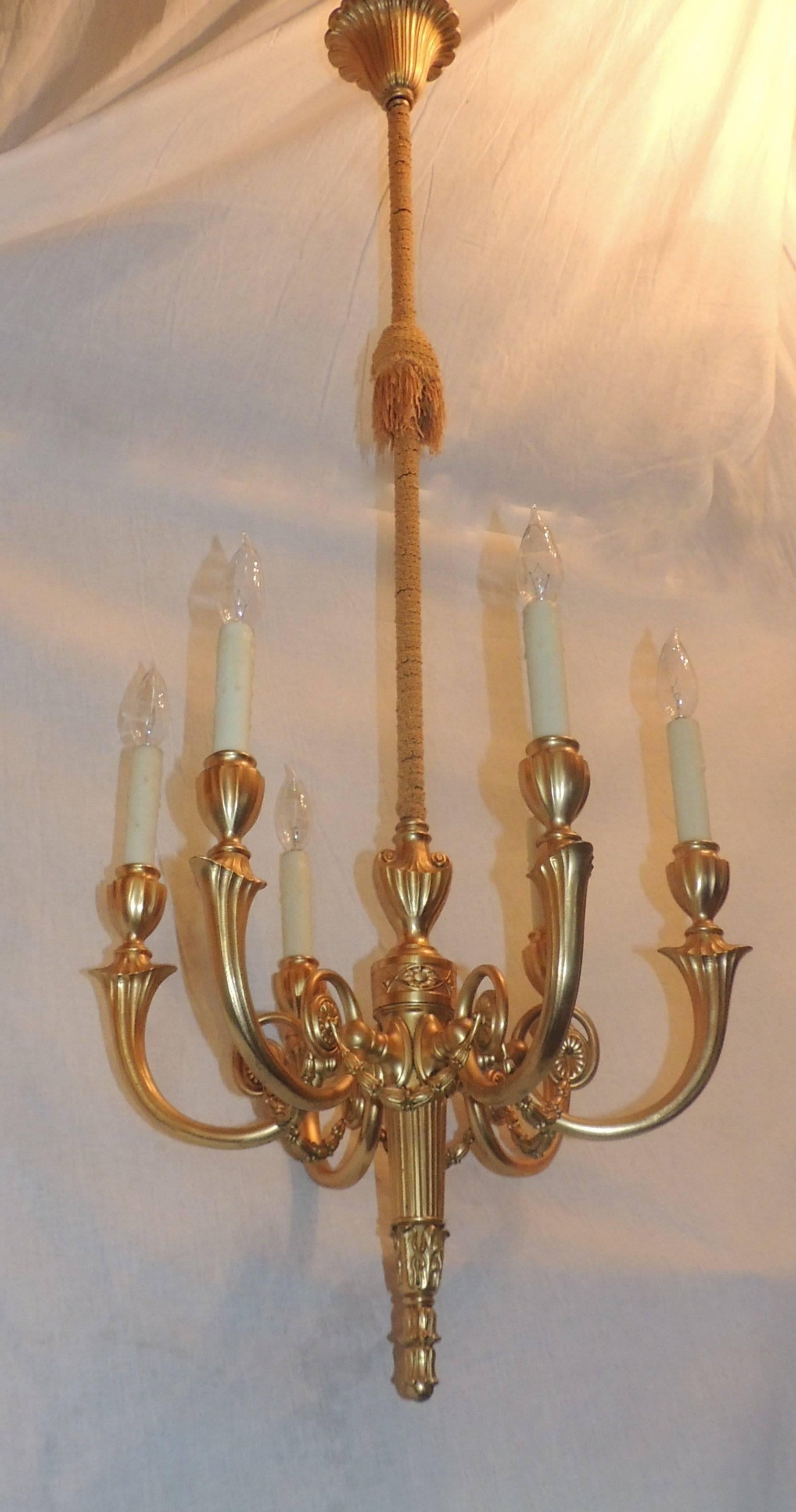 Wonderful Adams style gilt doré bronze swag chandelier adjustable six-arm fixture. Center top shaft of this handsome fixture is decorated with a bronze pole that has been dressed with a lovely gold ribbon. 
The entire fixture can be modified to