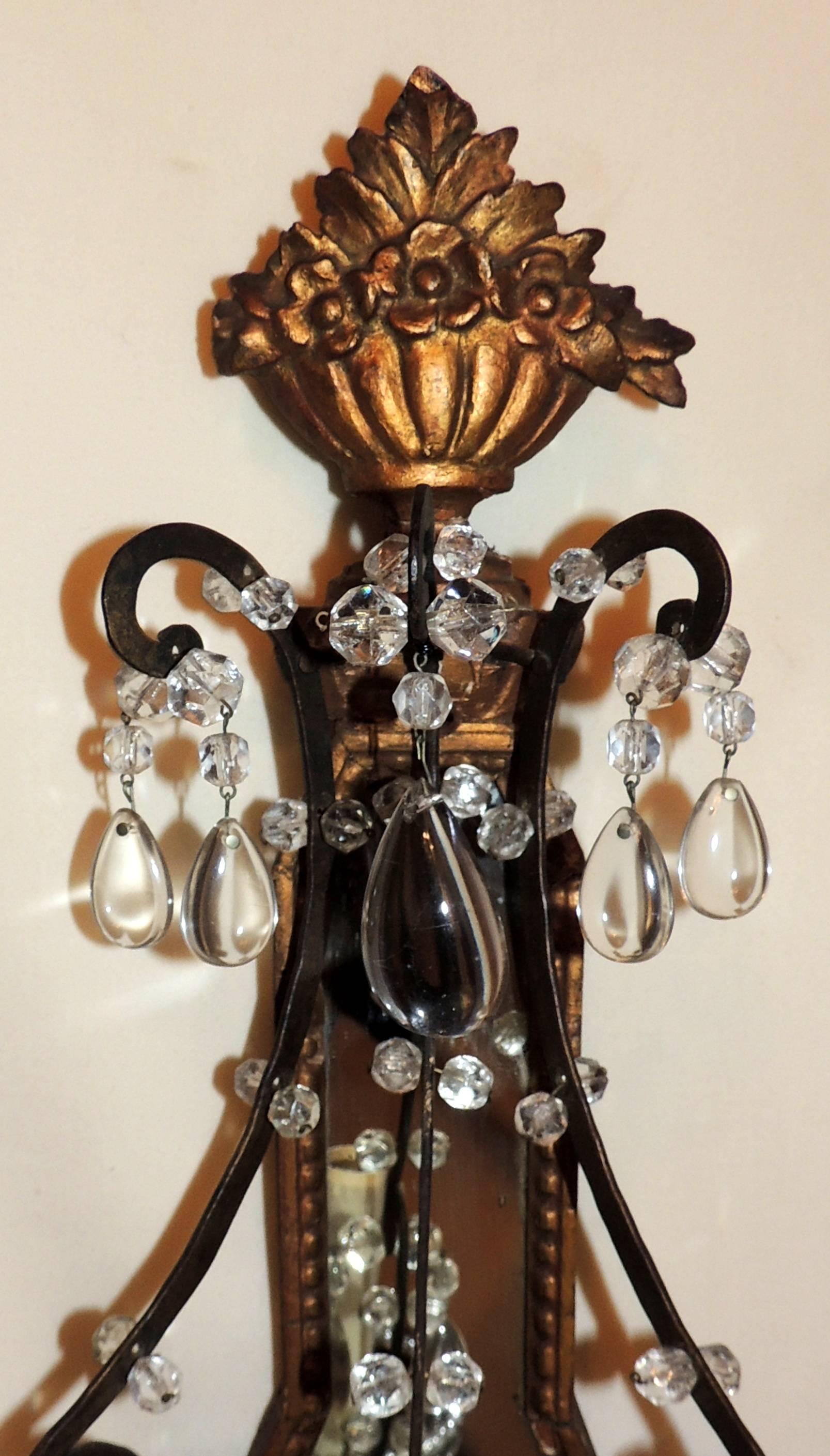 Wonderful pair of fine beaded, mirrored back carved wood Jansen style gilt and hand iron Bagues style three light crystal sconces. Minor wear to gilding, some of the beads and crystals have been reattached but still retain the look of old.