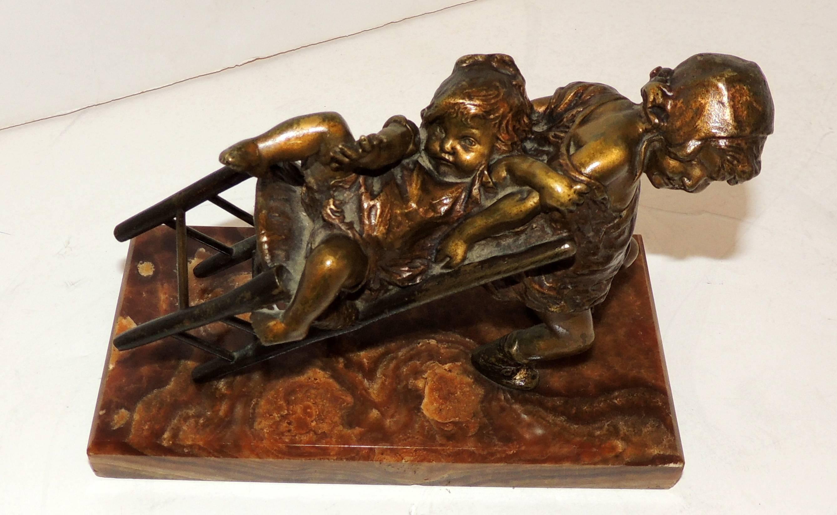 Wonderful signed patina bronze sculpture by Juan Clara Ayats on an onyx base of two girls playing with a chair, Spanish artist (1875-1958).
  