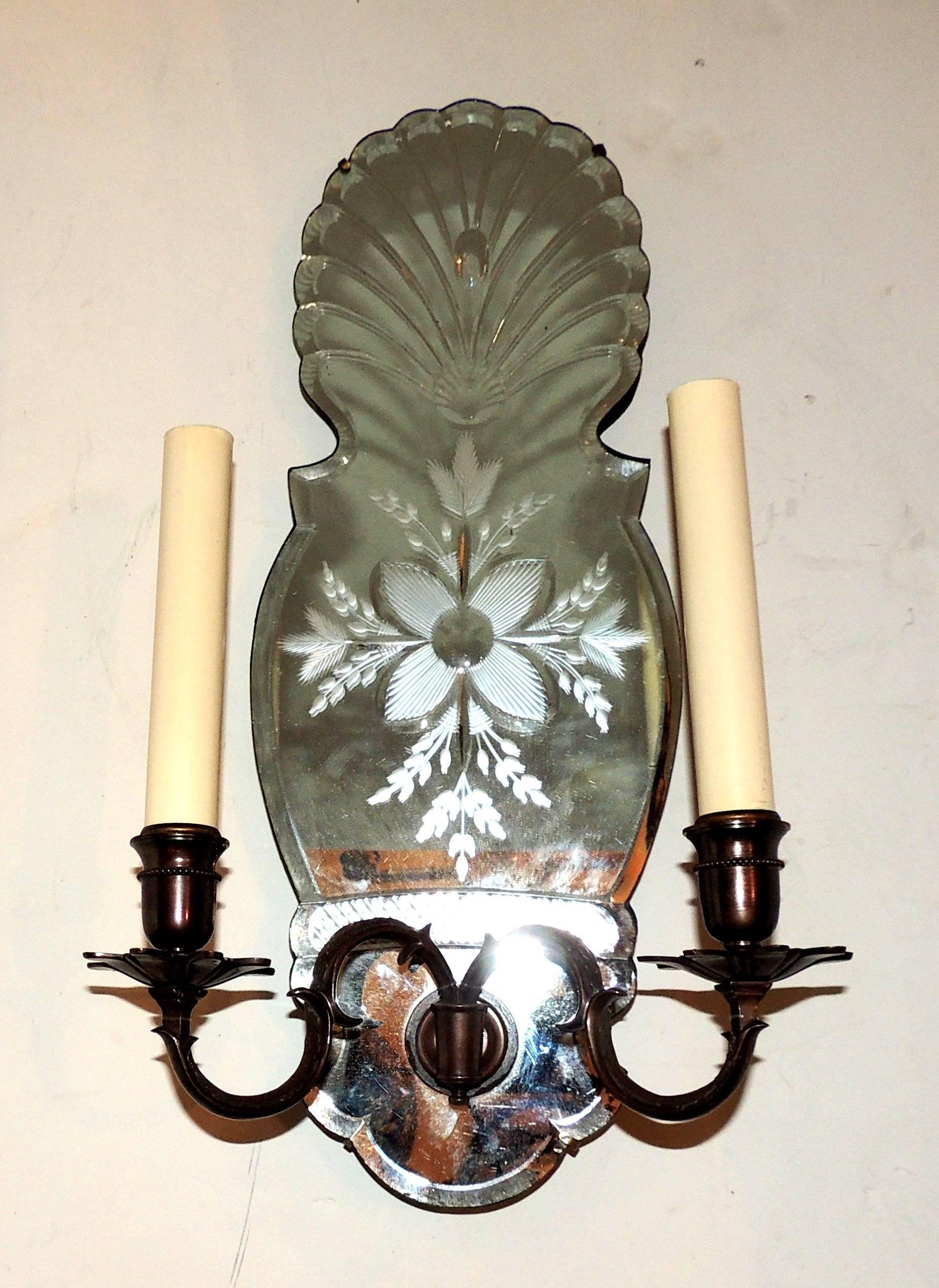 Wonderful pair of etched floral mirror back two-light patina bronze classical sconces in the manner of Caldwell.

Measures: 20" H x 10" W x 6" D.