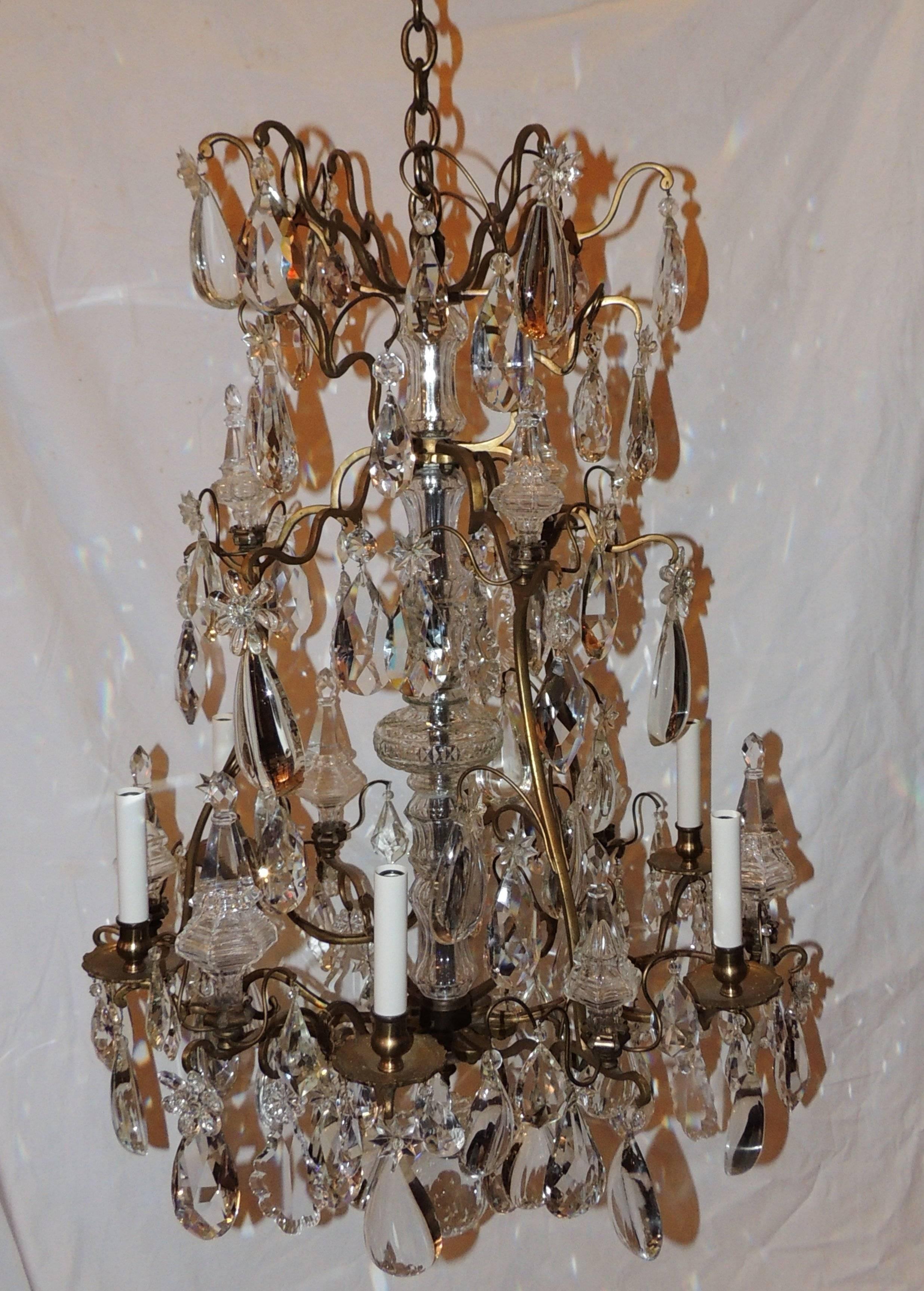 Wonderful doré bronze six light Baccarat Style chandelier with beautiful faceted crystal centre, faceted and crystal pendants throughout this multi level chandelier with Crystal Obelisks accenting the layers. 

Measures: 40 H x 26 W.