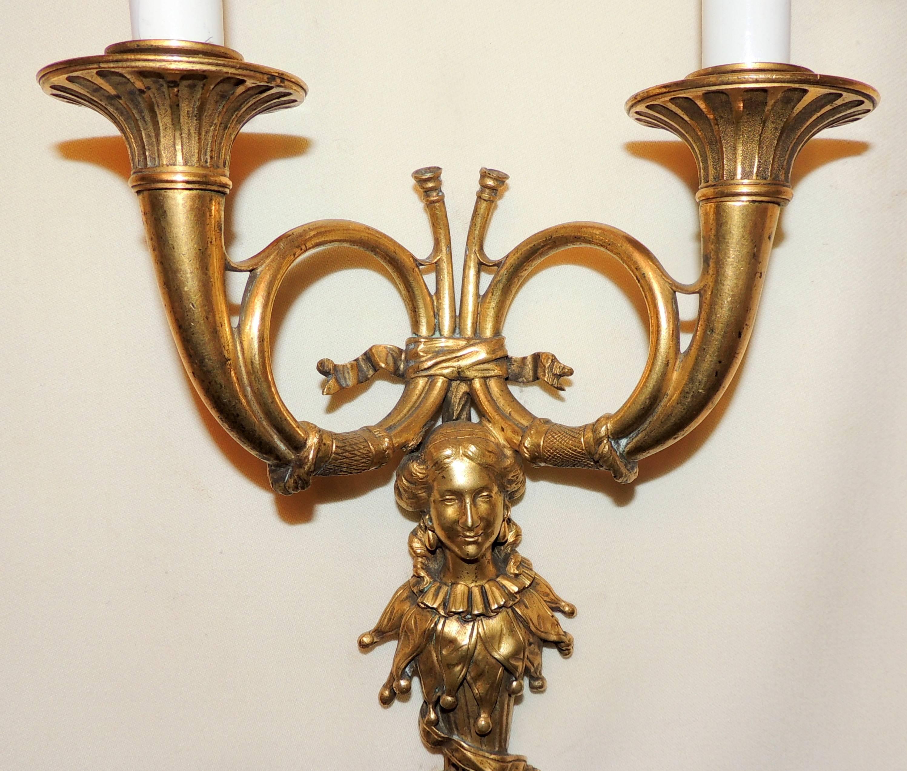 A wonderful pair of French horn Doré bronze lady figural two light tasle regency wall sconces.