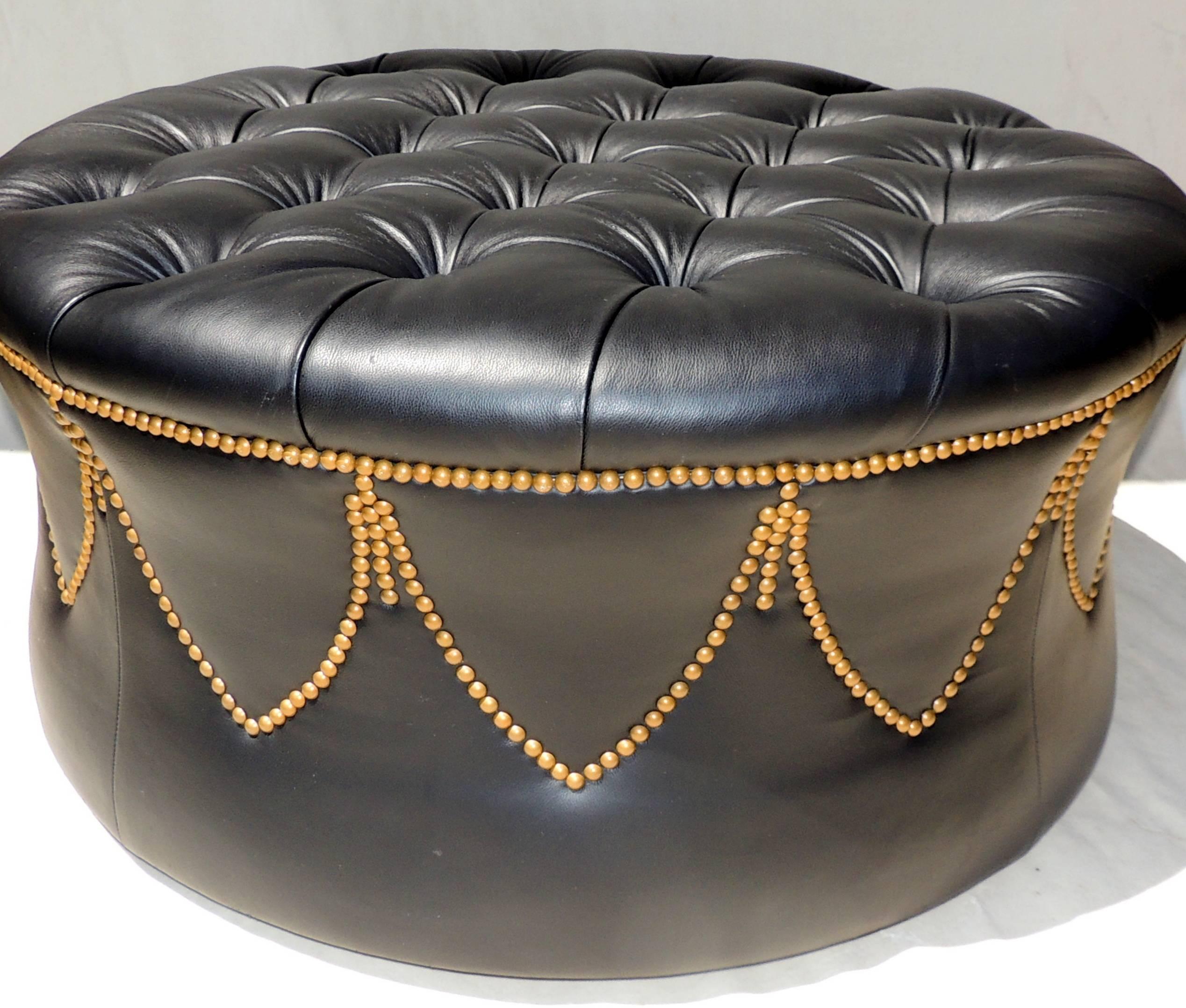 A handsome black leather leatherette brass nailhead tufted puff ottoman round bench footrest, great for any space.