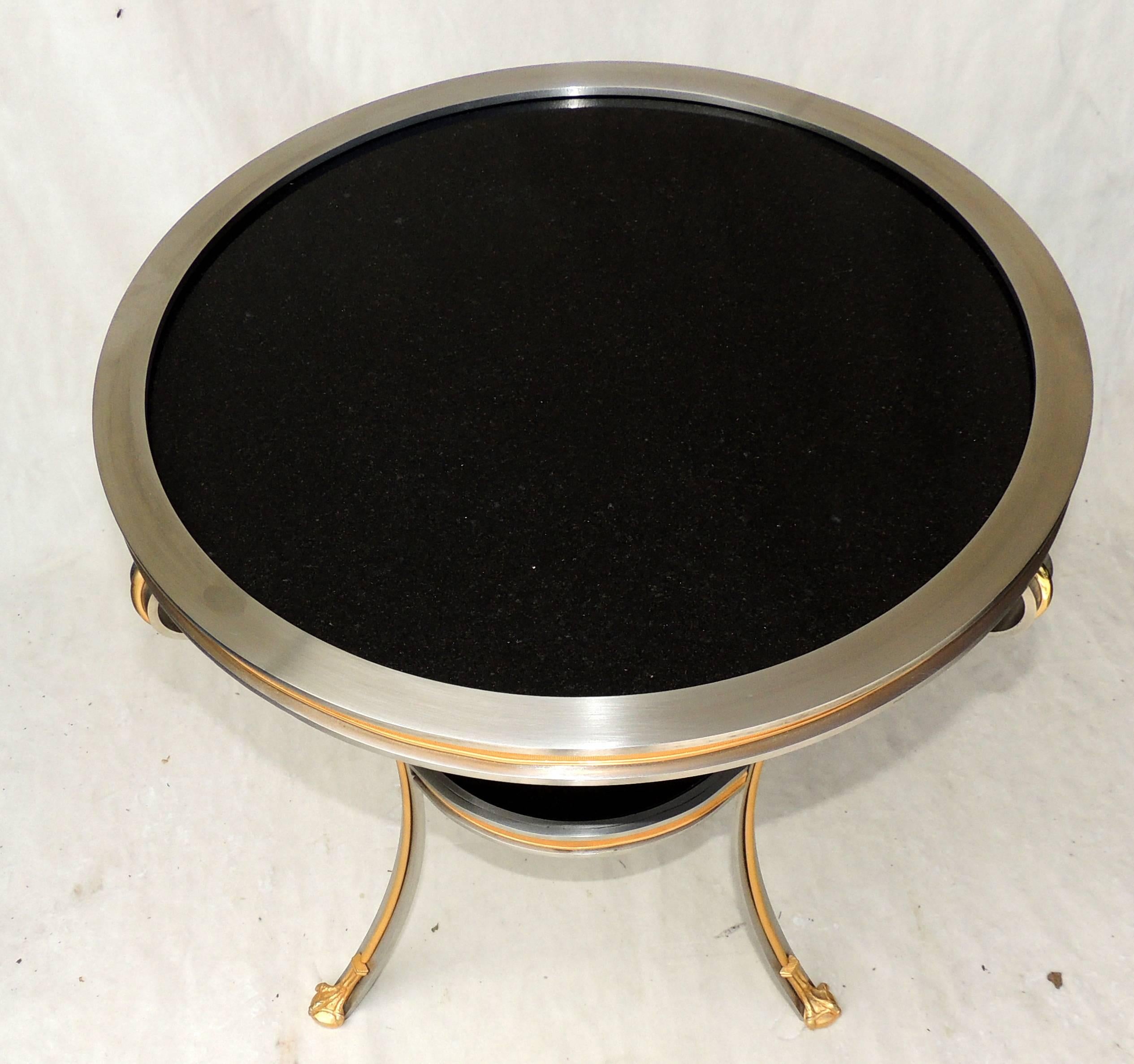 A Mid-Century Modern transition brushed silver steel bronze inset ormolu-mounted gueridon table with black granite stone by Mansfield Manor.