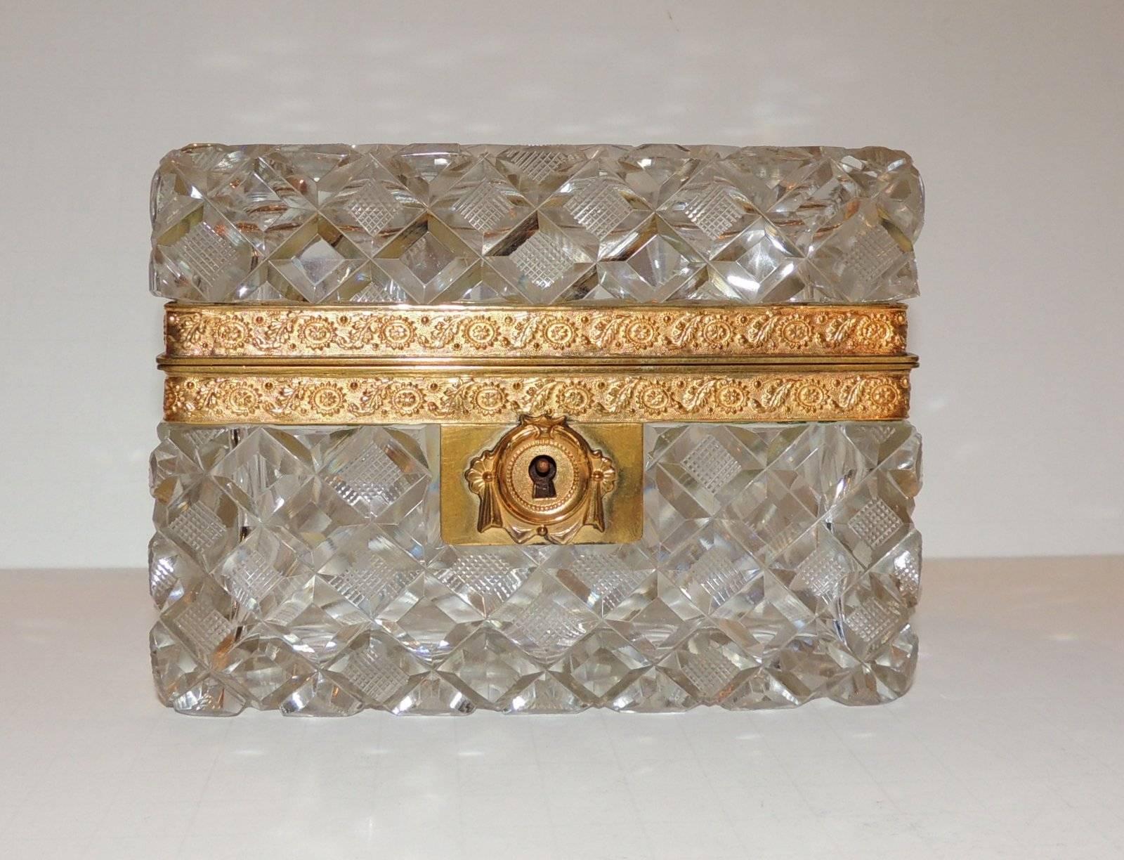 A beautiful cut and etched crystal within diamond pattern with engraved bronze ormolu mounting and draped keyhole.

Measures: 5" L x 4" H x 3.5" D.