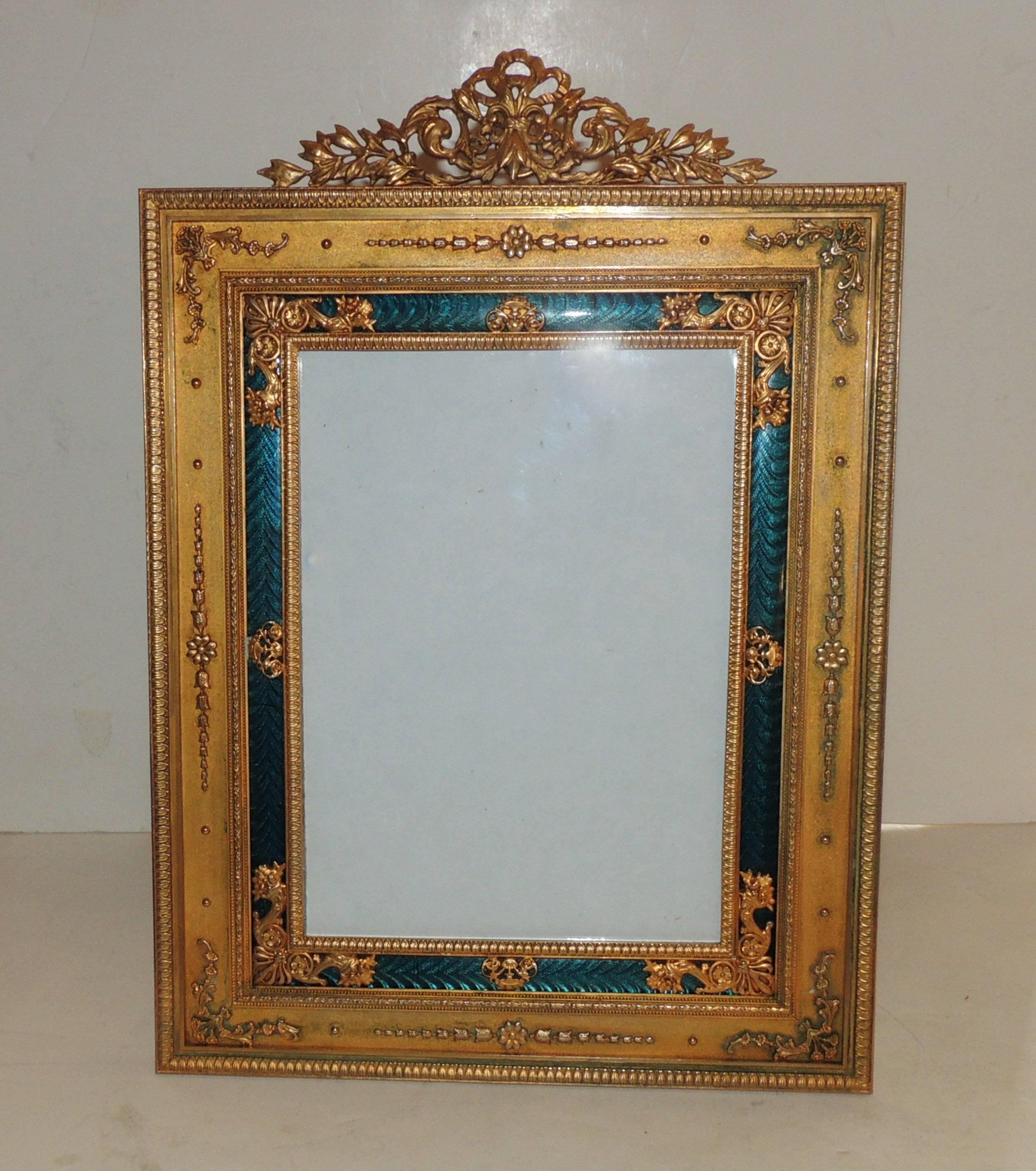 Very finely detailed French empire doré bronze and green enameled frame with original stand.

Measures: 12