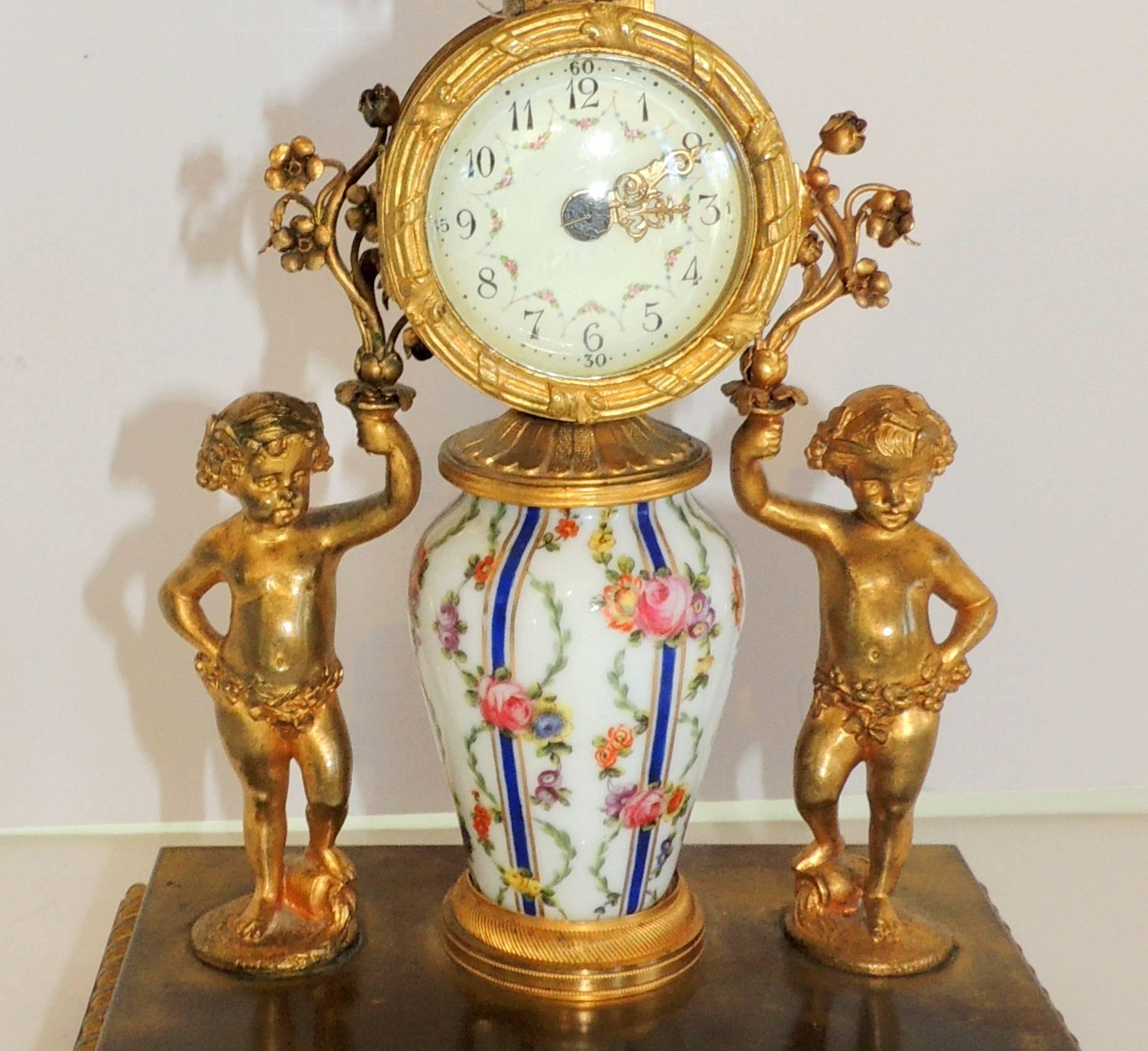 A wonderful French hand-painted porcelain and ormolu doré bronze-mounted cherub / putti clock.
 