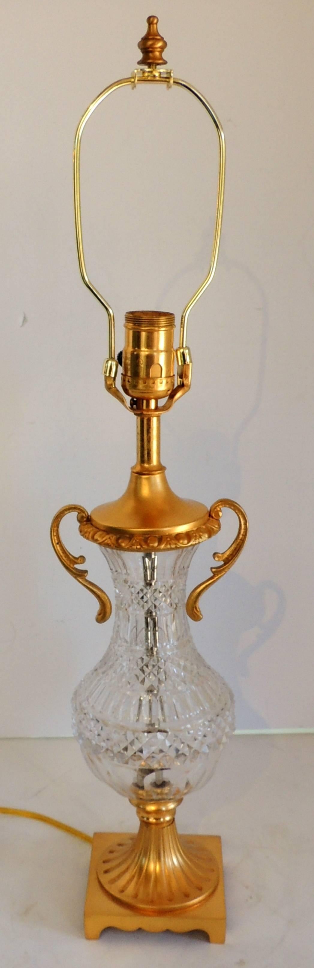 A wonderful pair of French gilt dore bronze and cut crystal urn form ormolu-mounted lamps.