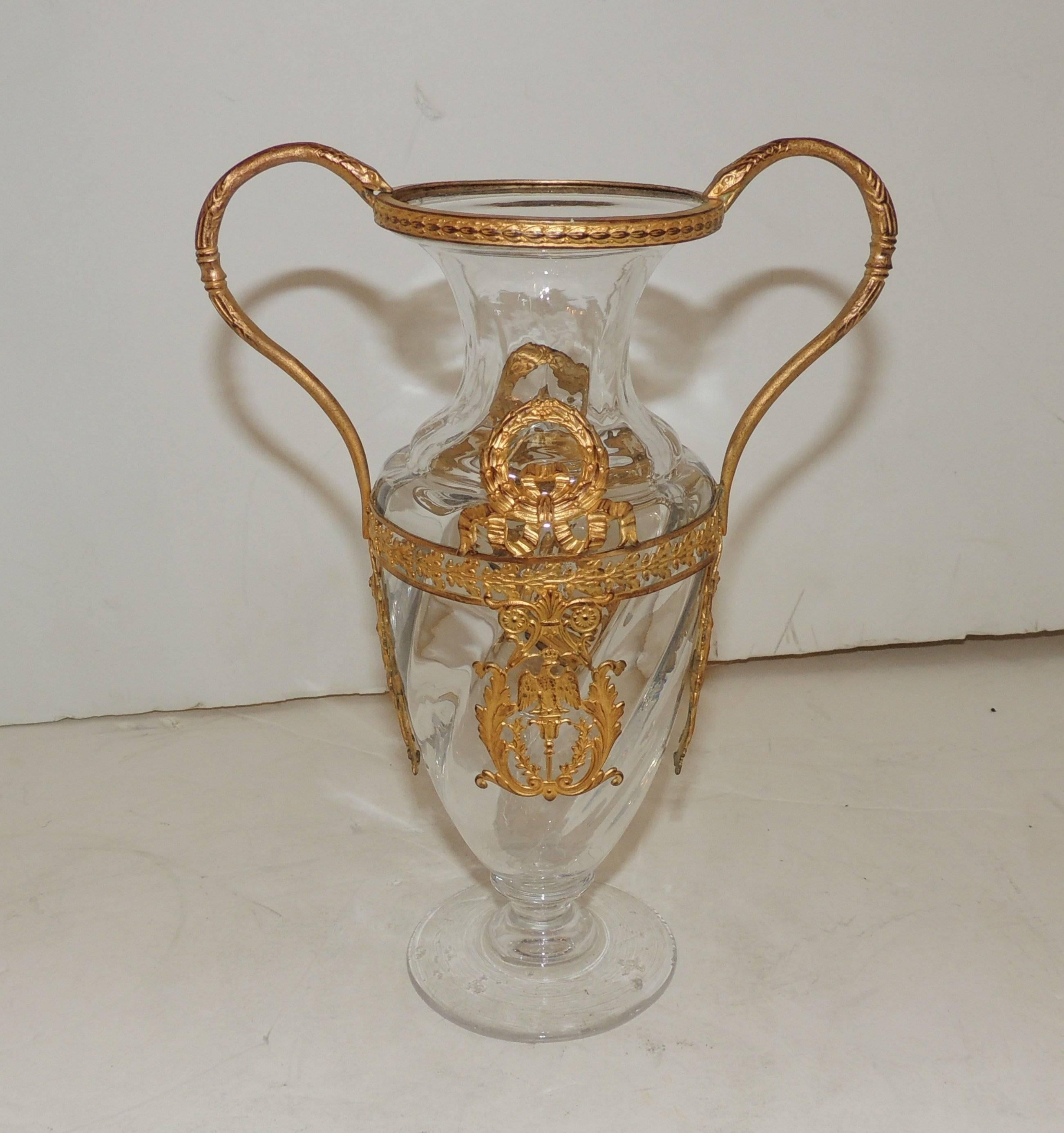 Wonderful crystal pedestal vase with draped wreath and floral details and ribbon accents. Finely detailed bronze though out the top and bottom rim. There are female figures with wraths on each handle.

There are minor chips on the bottom.