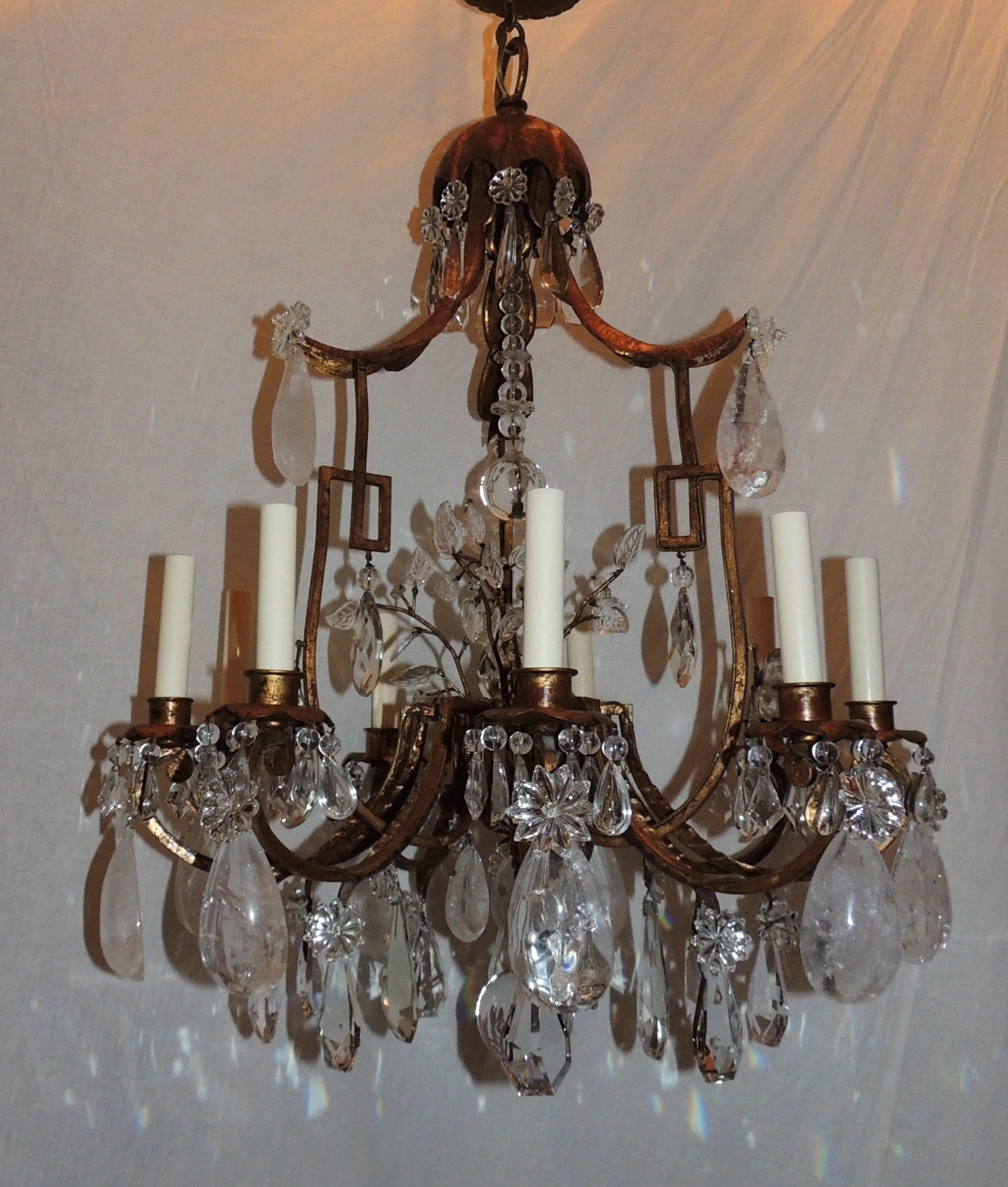 This is a fabulous and large pagoda form chandelier that has a beautiful center with crystal flowers topped with crystal beads and crystal ball. Each of the nine scrolled arms have a wonderful mix of faceted and rock crystal. The chandelier is