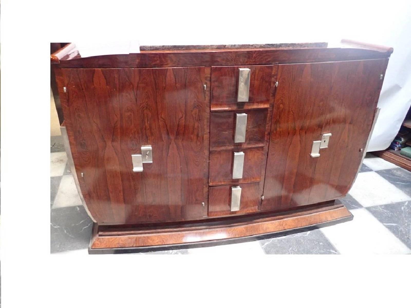 A wonderful and unusual U-shaped body, this 1930s French Art Deco buffet has match veneered rosewood.
The centre has four vertical drawers flanked by two doors with two interior shelves and original Pasquille (long bar locks)

Measure: 72