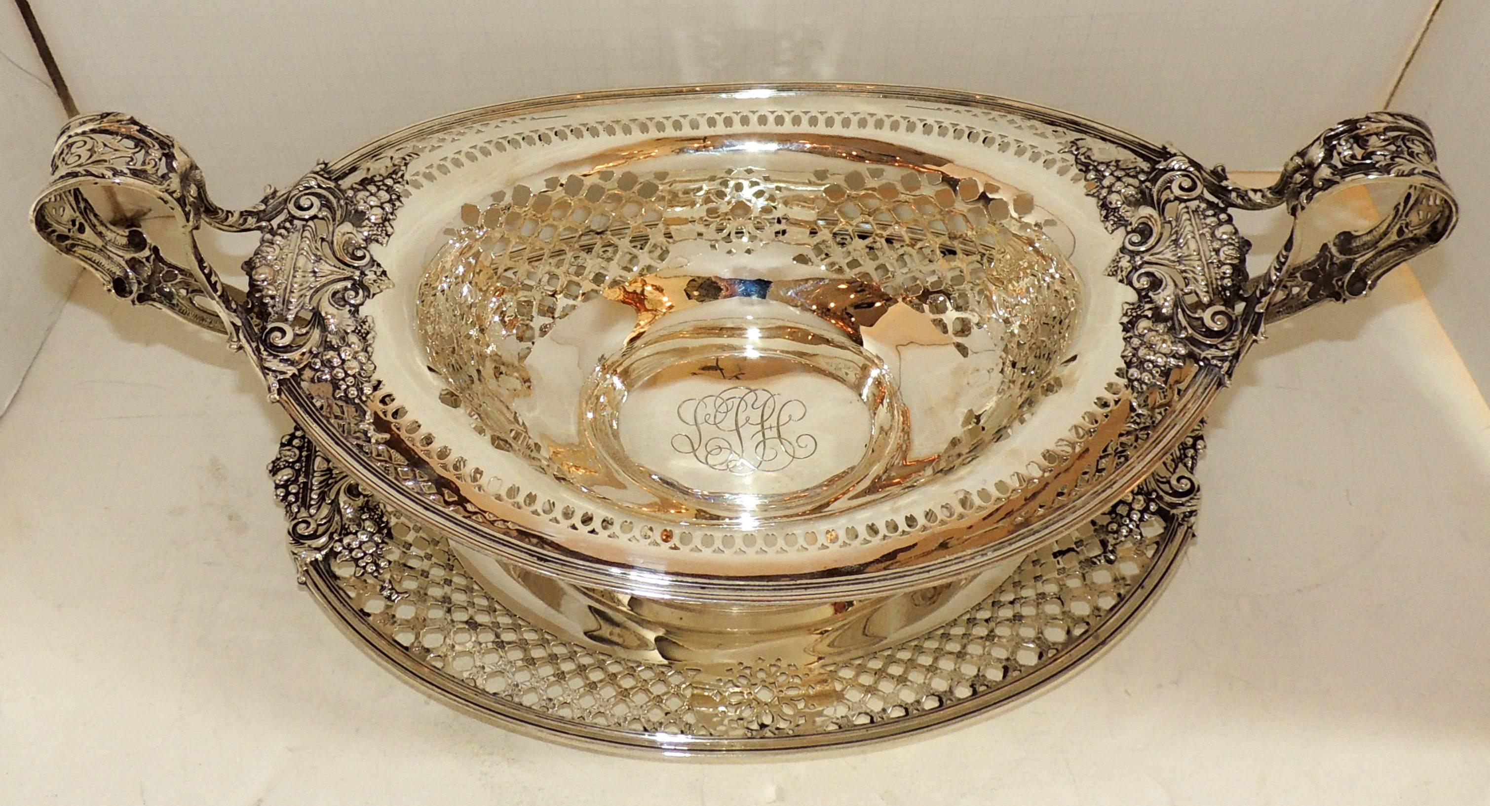 J.E. Caldwell & Co. Sterling Silver two-piece centerpiece with oval pierced handle bowl having urn and flower motif and matching under tray.
Centerpiece 9" D X 9 1/2" H X 20" W
Under plate 16" W X 10 !/2" D X 1" H.
