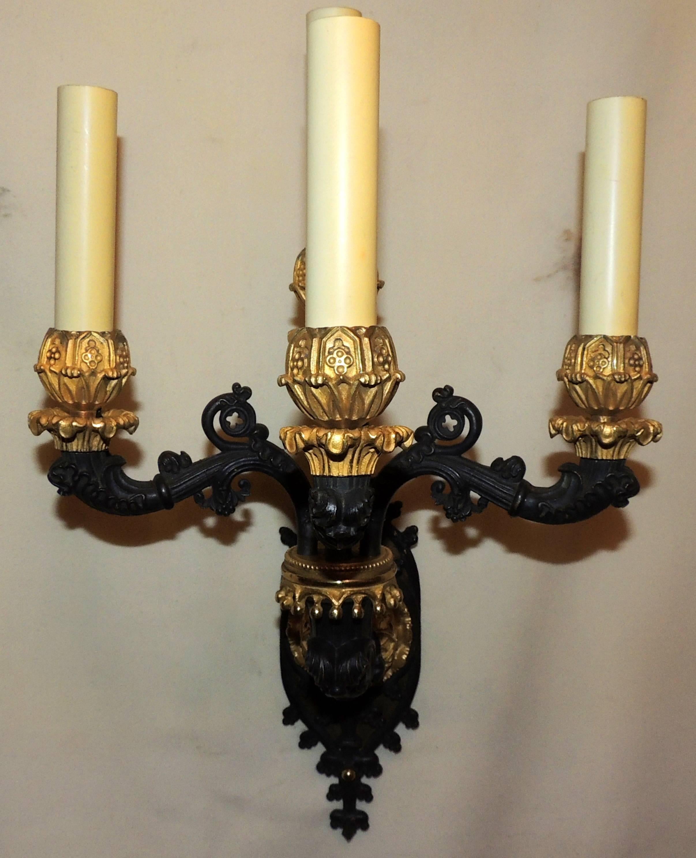 A wonderful pair of French Empire/neoclassical/Regency gilt bronze and patinated four- arm wall sconces.