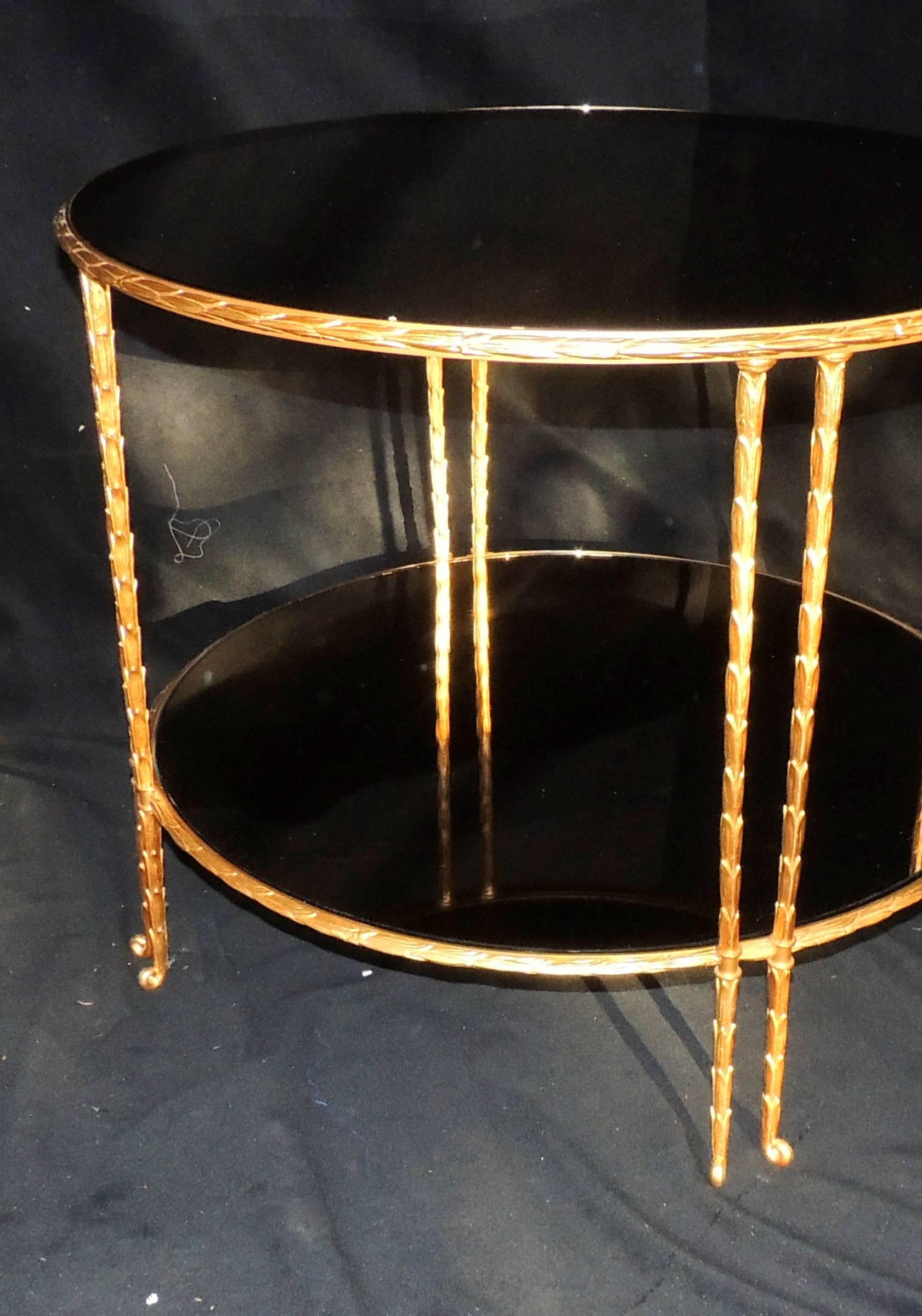 An elegant gilt bronze leaf form Maison Bagues & Guerin style
Two-tiered smoke mirrored side table.
Measure: 30 1/2