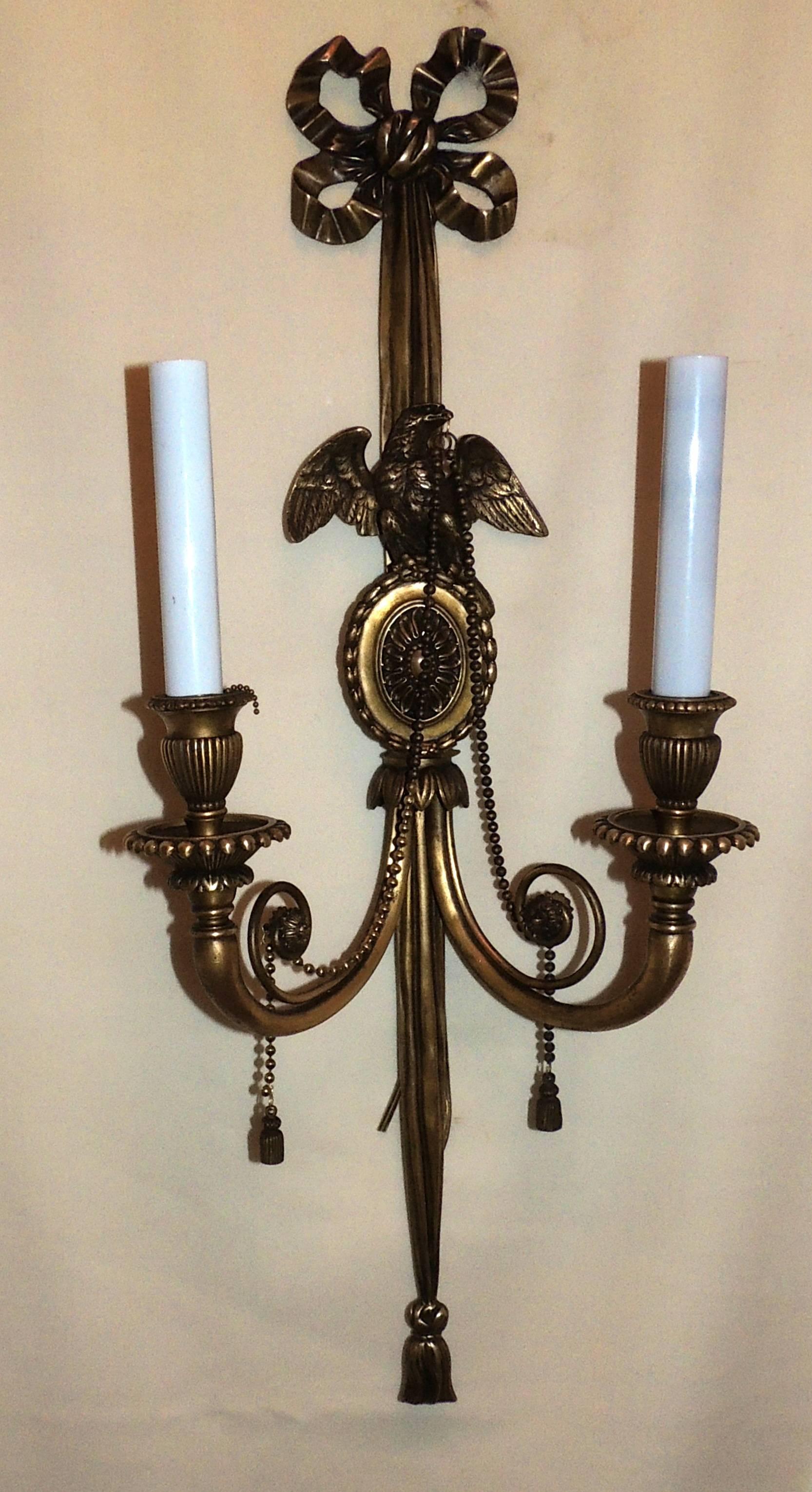 A wonderful pair of bronze neoclassical or Empire eagle centre medallion bow top and tassel sconces with beaded swags. Each with two sockets, completely rewired and ready to enjoy.