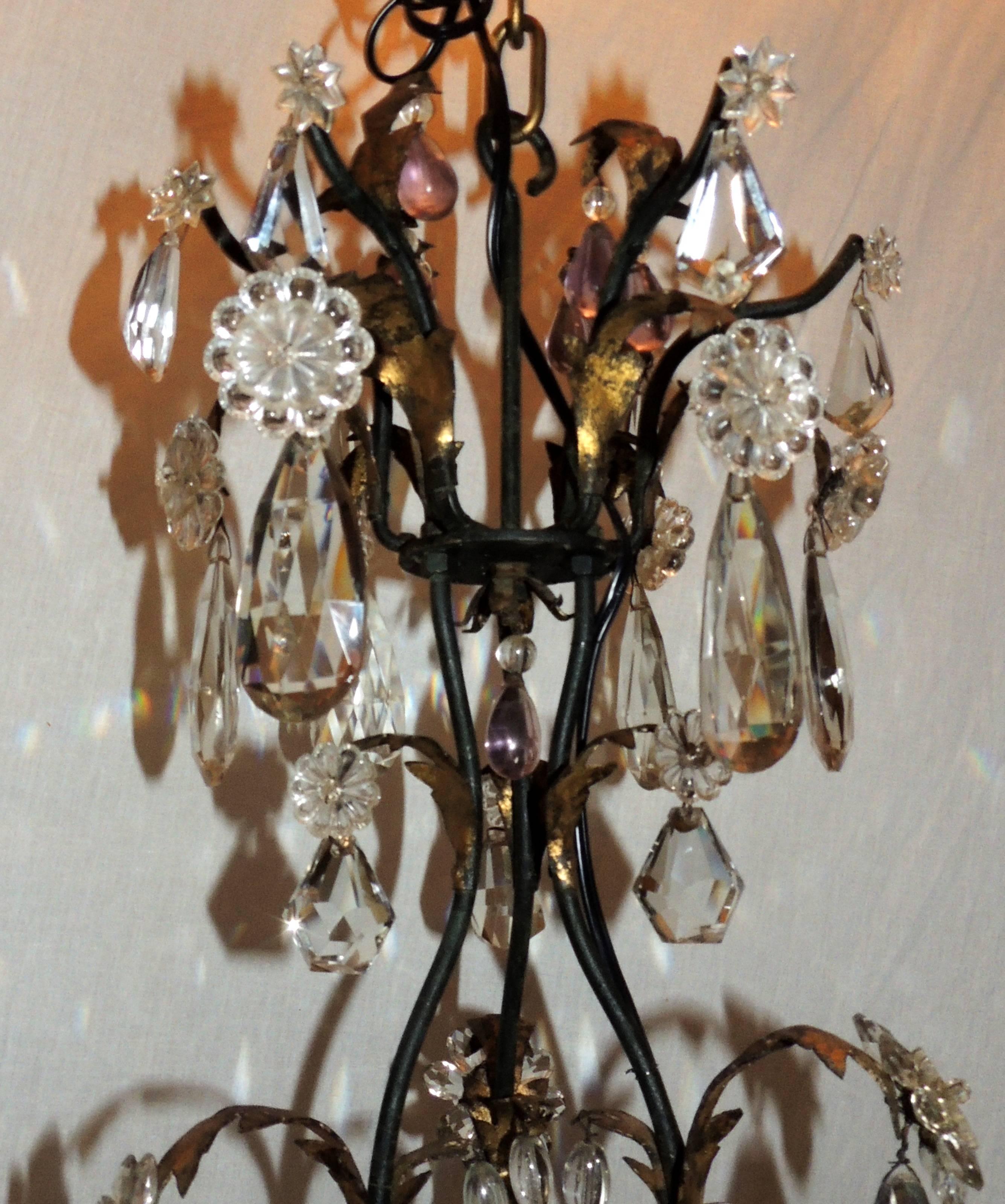A wonderful French iron and gilt, cut crystal chandelier in the Louis XVI & Baguès manner with six candelabra lights and enhanced with amethyst crystals.