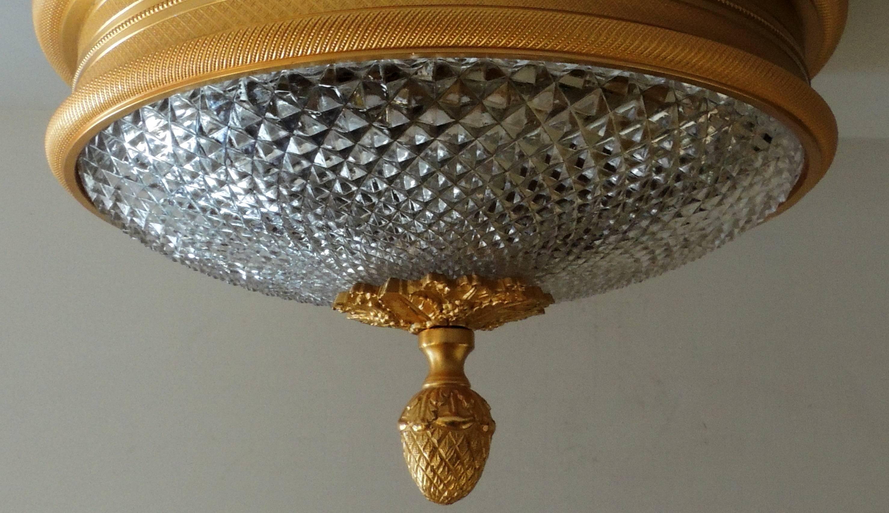 A wonderful neoclassical set of four Sherle Wagner vintage knurled ceiling lights in doré bronze gold patina. These low profile two-light fixtures (max 60watts per socket) are perfect for lower ceiling applications. This beautiful flush mount is