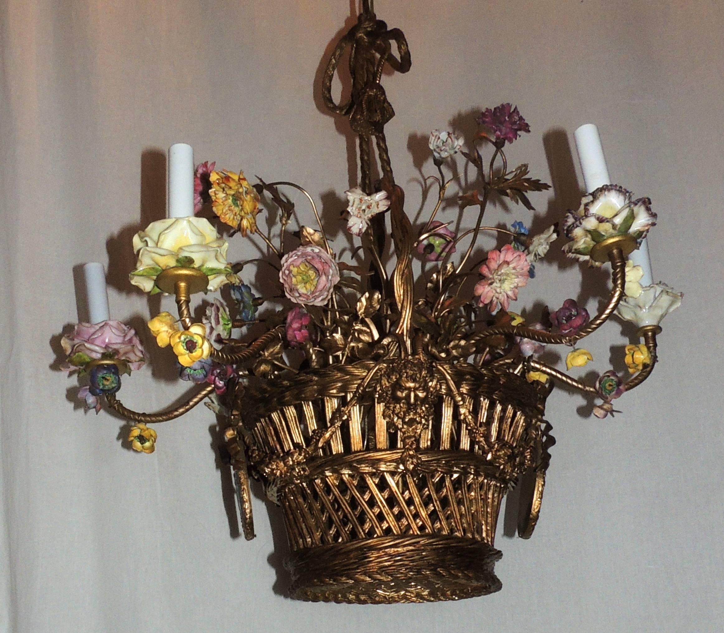 A Wonderful French bronze and porcelain flower woven form basket chandelier with two framed wedgwood plaques and alternating ormolu figures. Each of the six candelabra lights embrace a porcelain flower form cup and the entire centre of the
