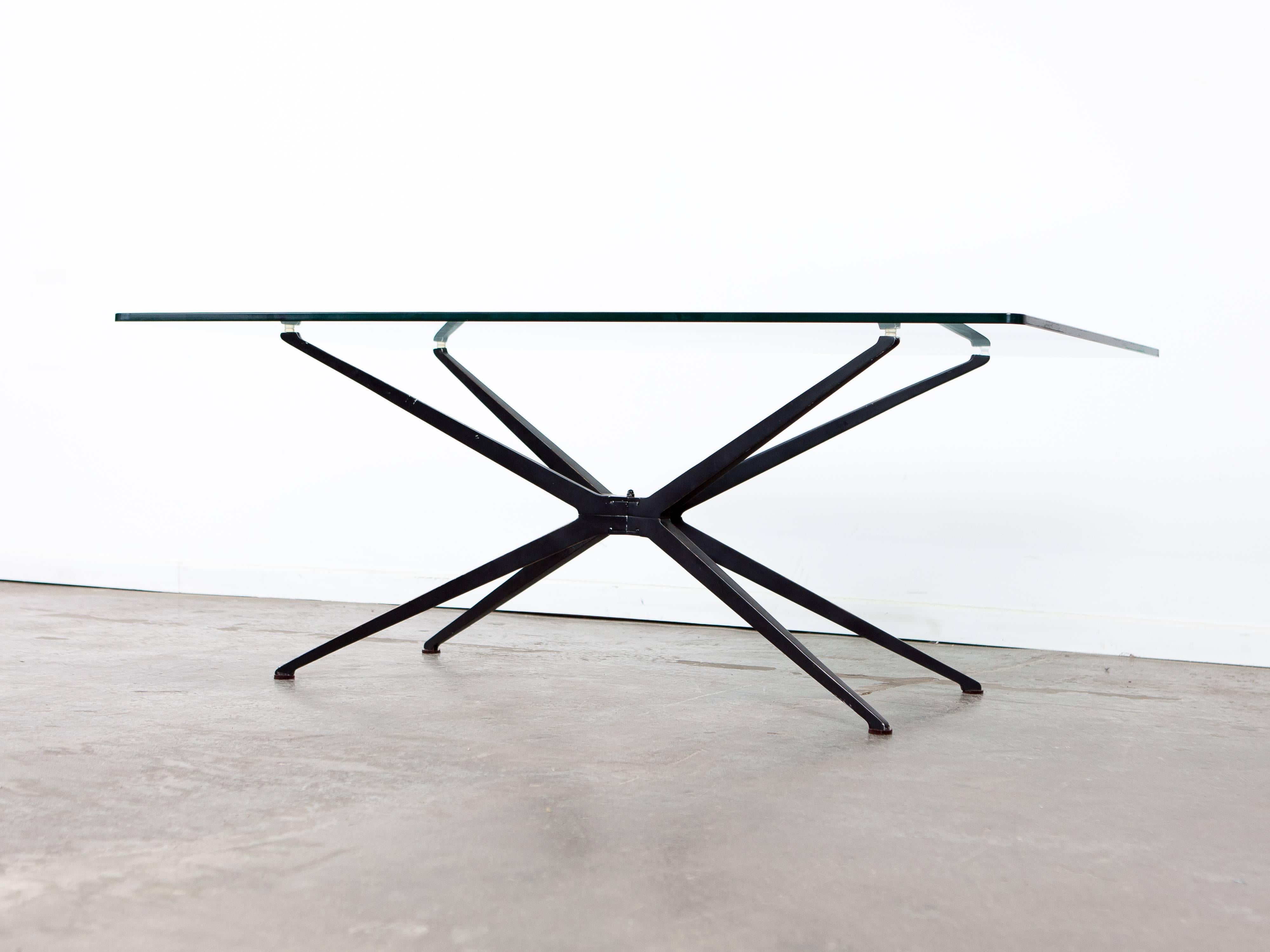 Unique Mid-Century Modern glass top coffee table with sculptural metal base.